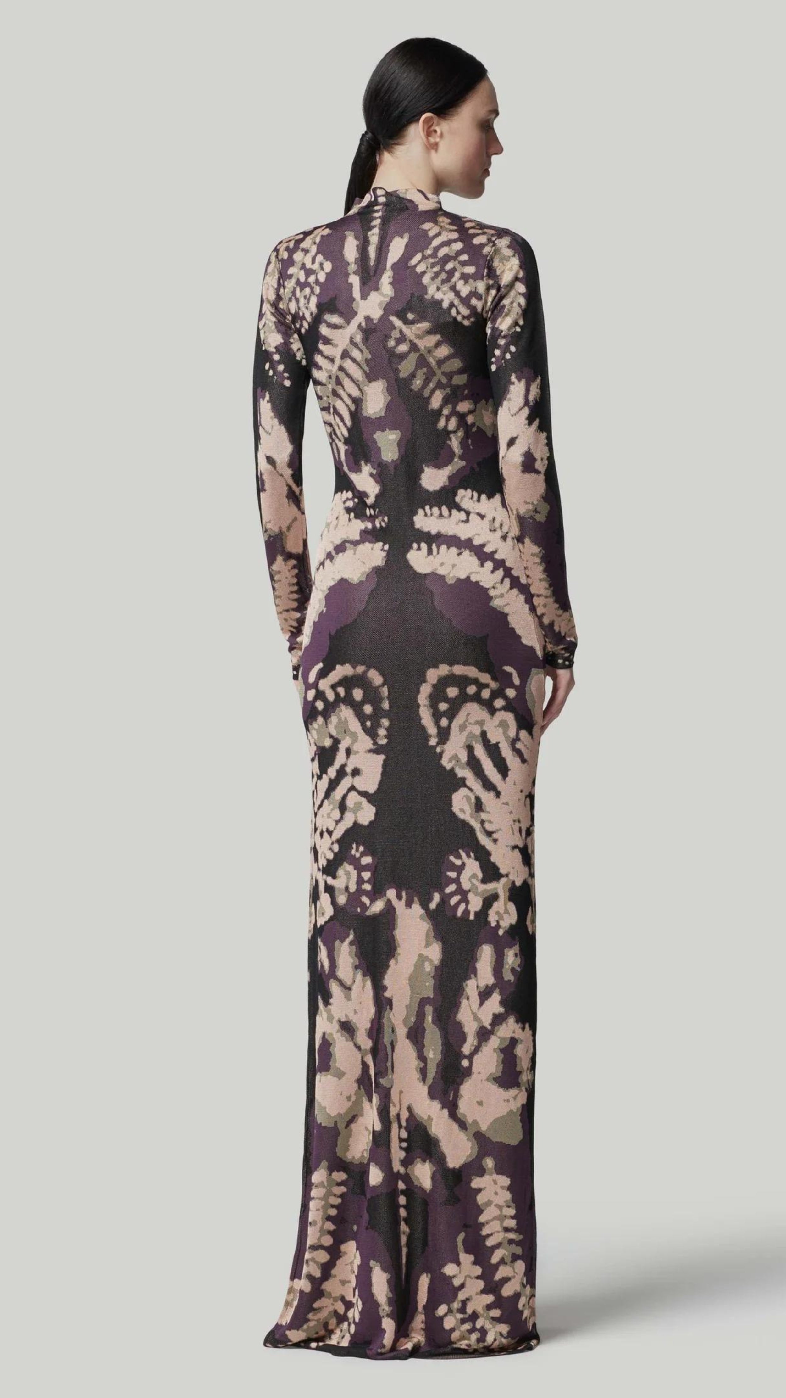 Altuzarra Rhea Dress. Knit dress in the rorschach in deep purple and pale pink. with a mock turtleneck, long sleeves and maxi length. Shown on model facing back