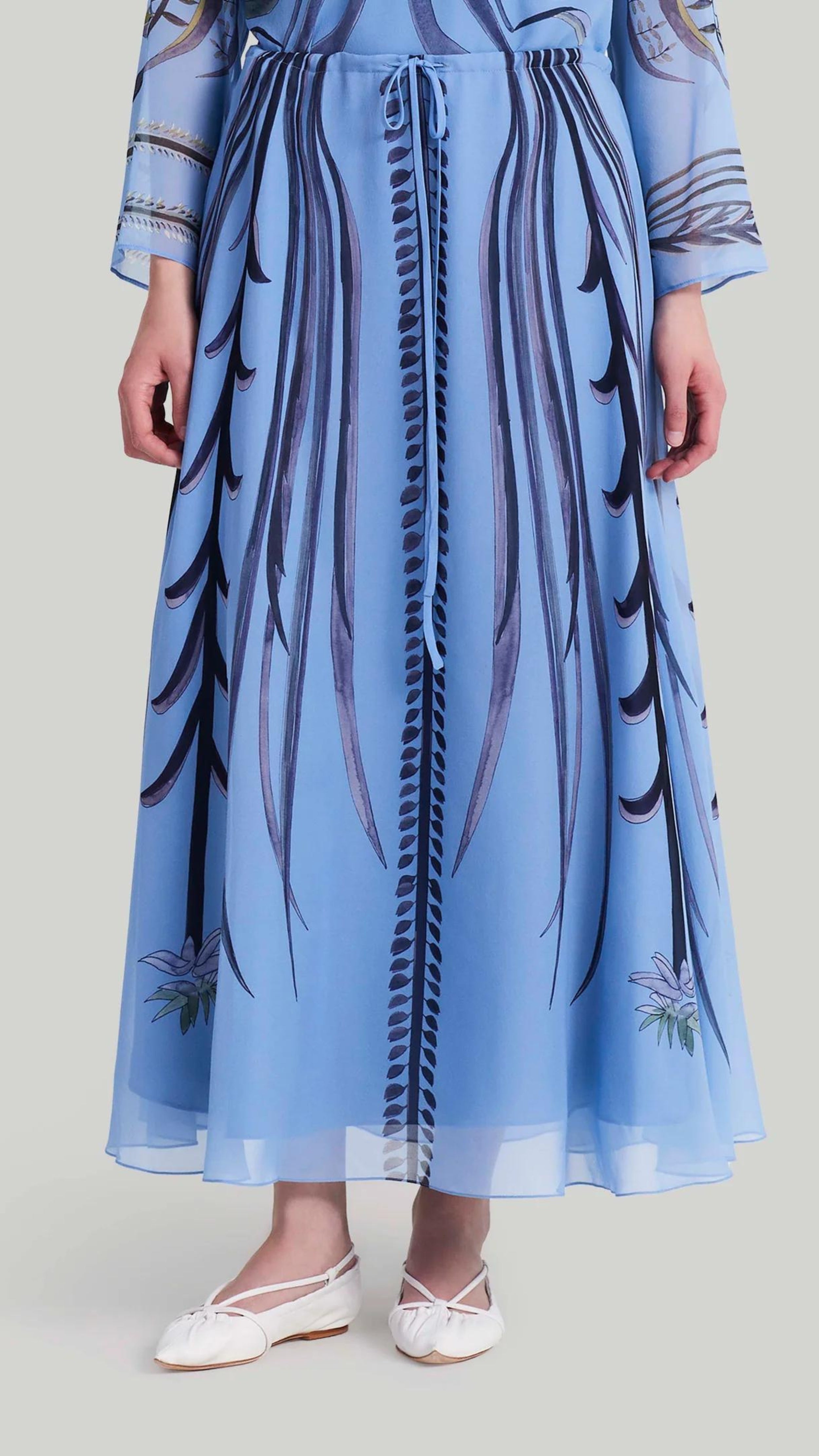 Altuzarra Roxana Skirt. Sky blue, navy blue and violet highlight. Hand painted skirt with adjustable tied at the waist. Midi length. Natural pattern. Shown on model facing front