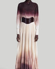 Altuzarra Sif Skirt A tailored maxi skirt with a straight high waistband and a voluminous pleated skirt. Made from 100% Italian silk it is dip dyed in an ombre of in cranberry to ivory coloring. On model facing front.