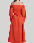 Altuzarra Zora dress shirt dress style soft cotton midi dress in red orange color. Made in Italy. The dress has off the shoulder neckline, puff sleeves and an elasticated waist waistband. Shown on model facing back