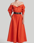 Altuzarra Zora dress shirt dress style soft cotton midi dress in red orange color. Made in Italy. The dress has off the shoulder neckline, puff sleeves and an elasticated waist waistband. Shown on model facing front