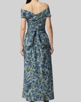 Altuzarra Corfu Dress in Stormcloud Shibori Flower. Relaxed off the shoulder cotton dress in beautiful grey blue, dark blue and yellow floral pattern. Wrap around style top with wrap around belt flows into the straight midi length skirt. Shown on model facing back. Available at experience 27 in madrid spain.