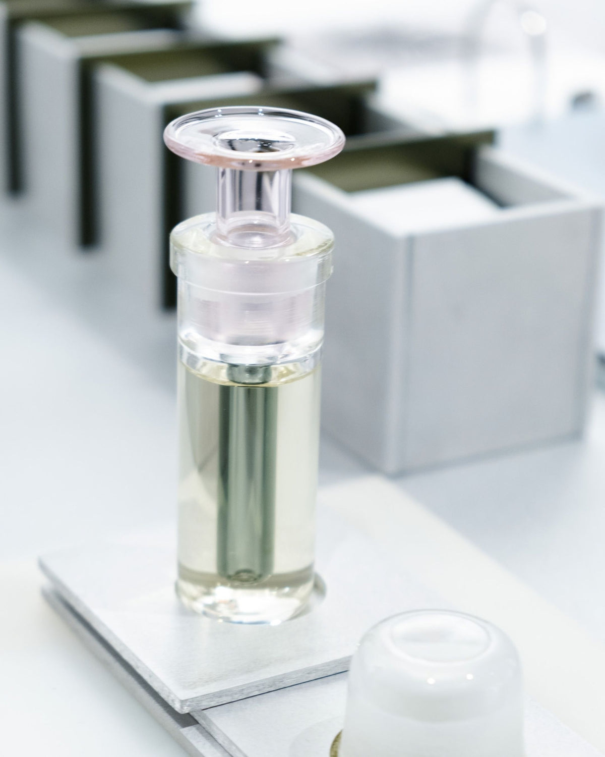 ARPA Ferragus 06 fragrance bottle displayed within a geometric mirrored installation