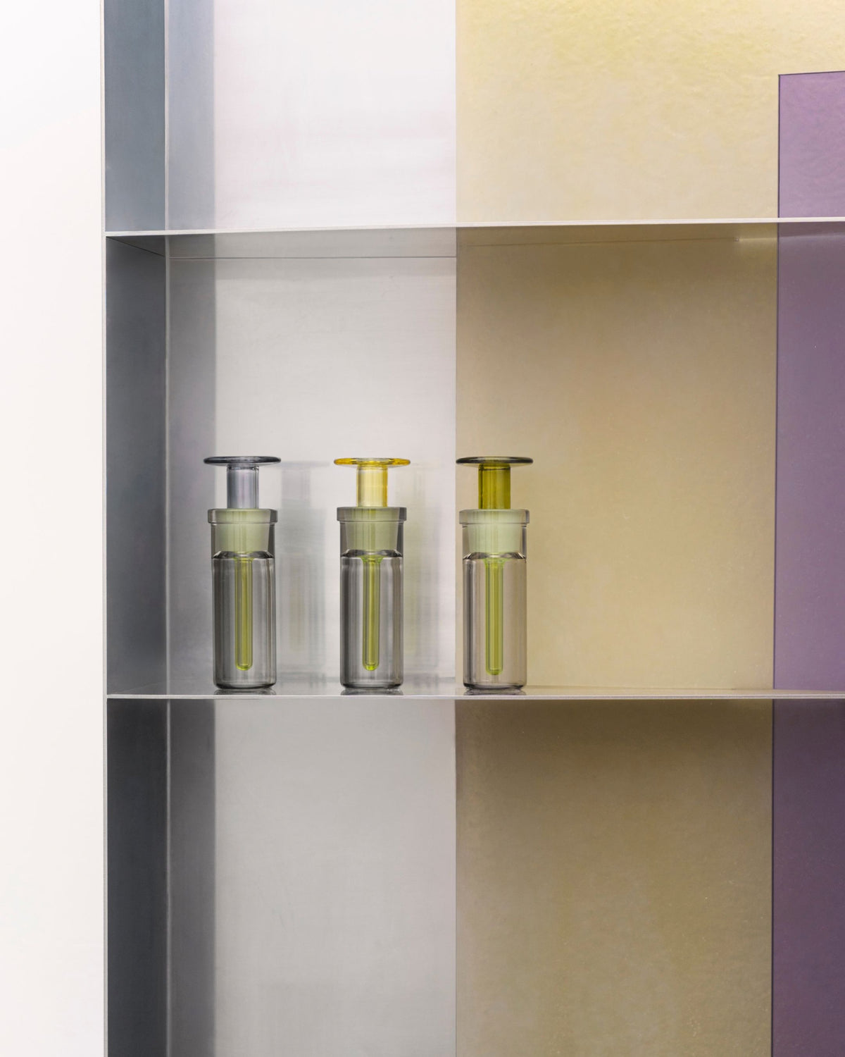 ARPA Piel 04 fragrance bottles displayed within a geometric installation