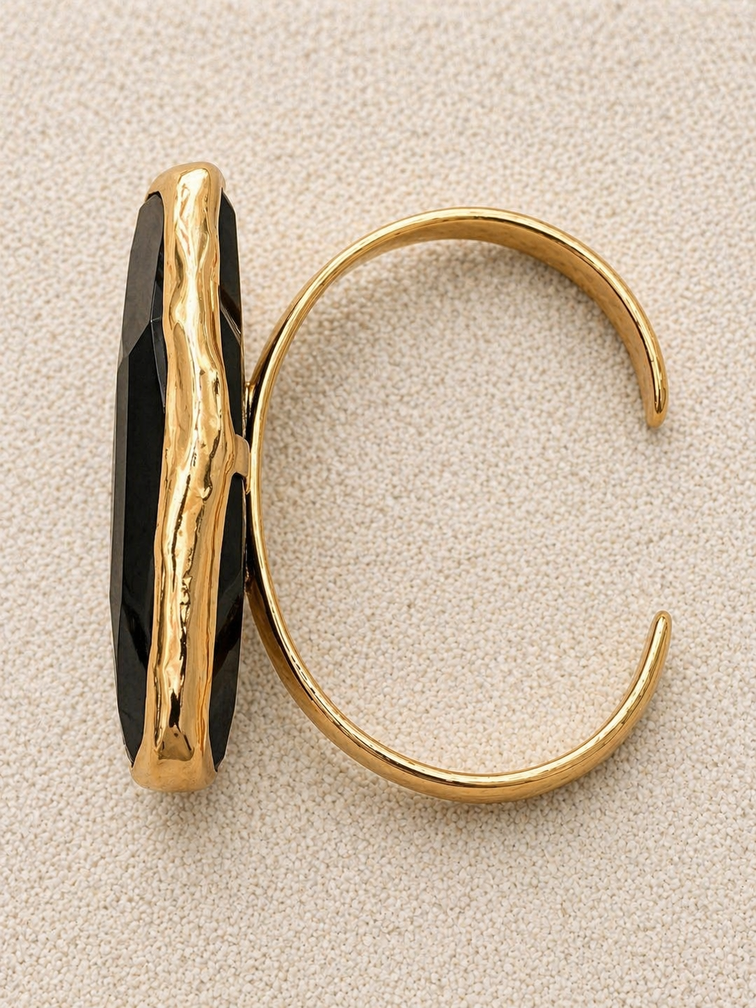 Françoise x Gas Bijoux Aura Bracelet, side view showing faceted black mineral glass stone in hammered gold bezel and open-back cuff