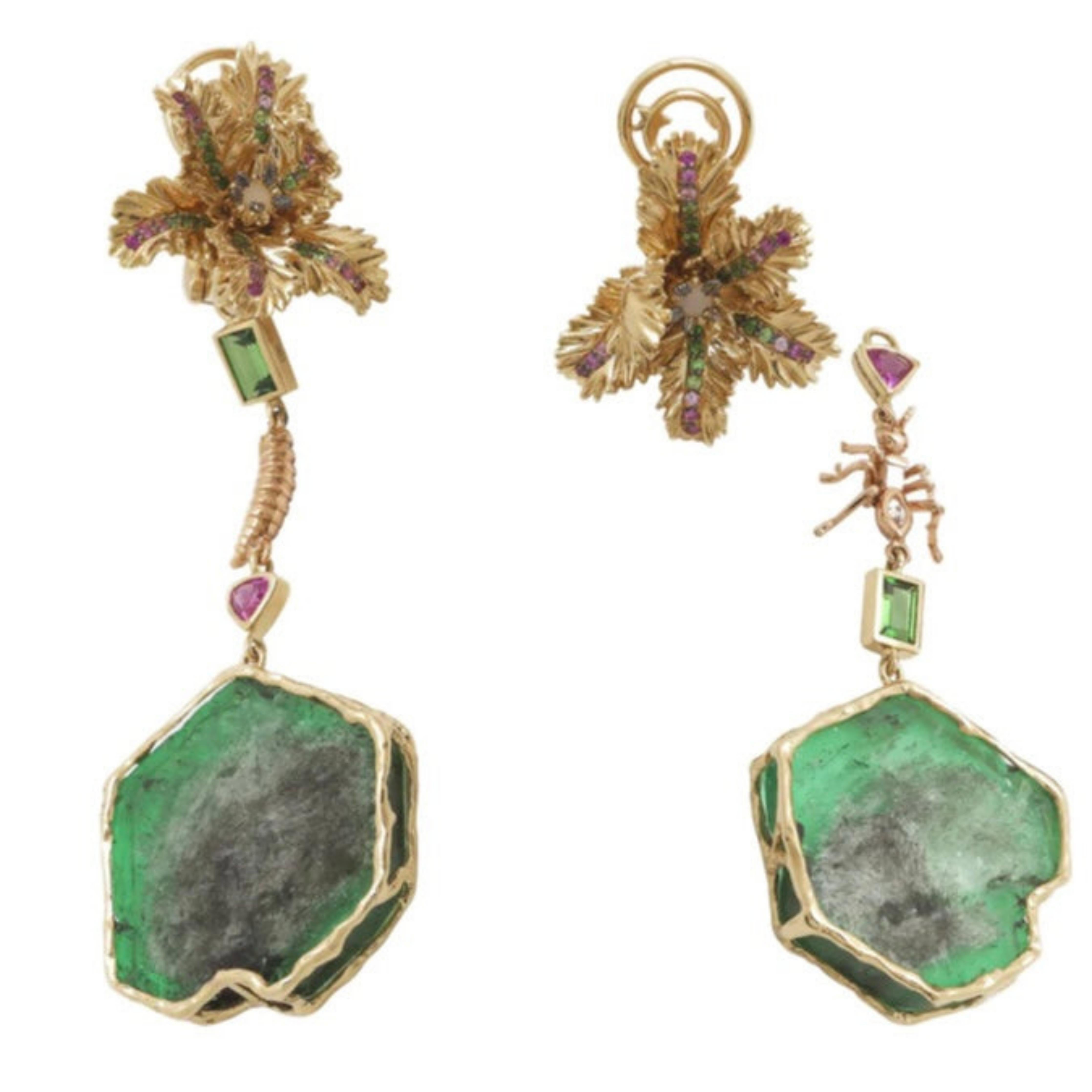 Bibi van der Velden Emerald Slice Earrings One-of-a-kind raw emerald slices set in 18K Yellow Gold flower studs set with pink sapphires, green tsavorites and an opal at the center. Each earring reveals unique details - one with a gold and diamond ant and the other with a rose gold maggot. The emerald slices can be removed to wear just the studs. Shown from the front view with detachable detail.