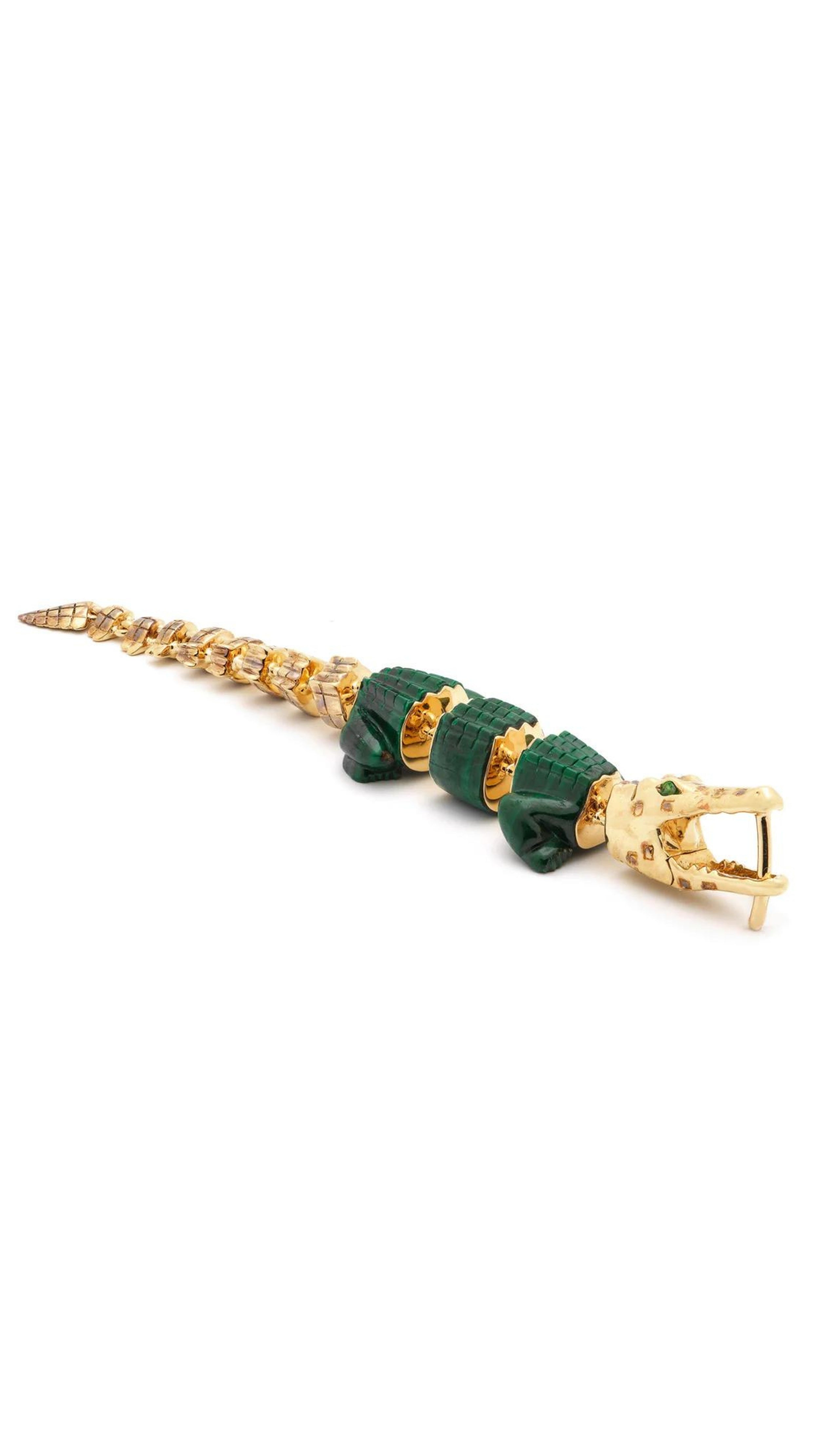 Bibi van der Velden Malachite Alligator Vertebrae Bite Single Earring. Hand-crafted 18K yellow gold earring with spine of the alligator and lifelike malachite body with Tsavorite accents. It has a unique bite clasp and moving tail. Shown laying flat