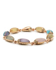Bibi van der Velden Mini Scarab Eternity Bracelet. Made in 18k rose gold, this bracelet has nine  scarab beetles, each made with translucent, matte gemstones in soft shades. The beetles' heads are paved with pale brown diamonds. Shown from the side view.