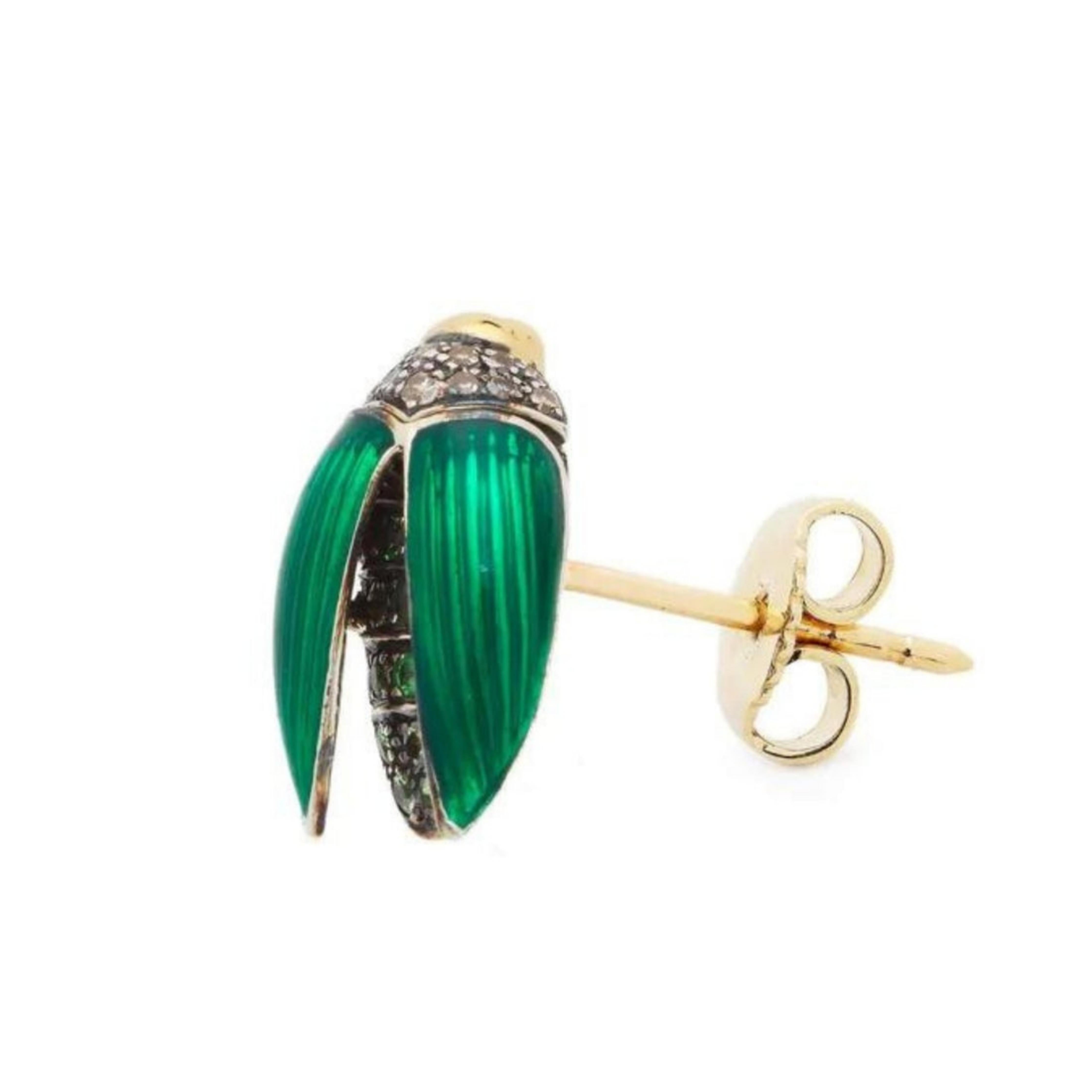 Bibi van der Velden, Mini Scarab Fly Wings Stud Earring. Crafted in 18K yellow gold and sterling silver, the earring features stunning green enamel wings and is decorated with brown diamonds and tsavorites.
