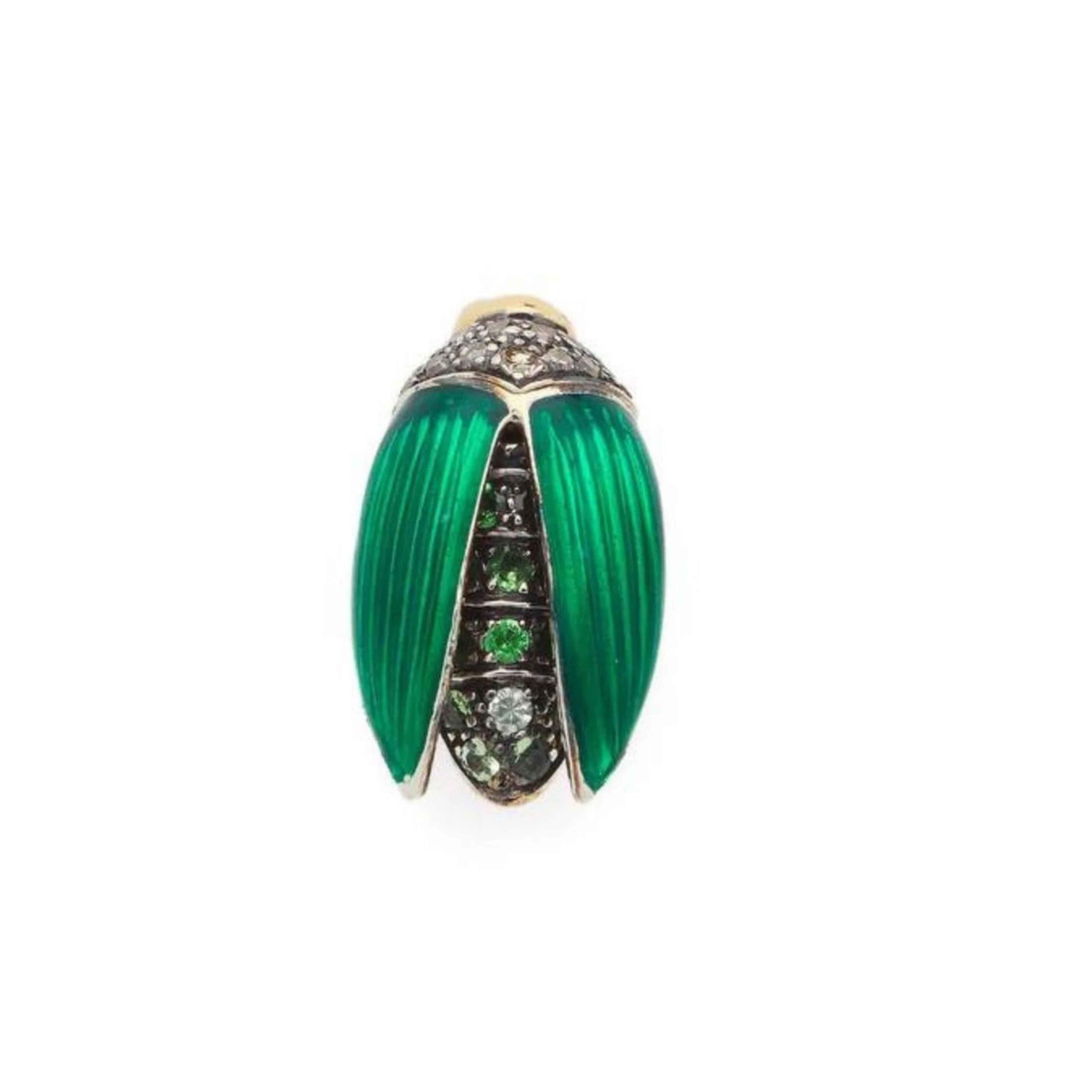 Bibi van der Velden, Mini Scarab Fly Wings Stud Earring. Crafted in 18K yellow gold and sterling silver, the earring features stunning green enamel wings and is decorated with brown diamonds and tsavorites.