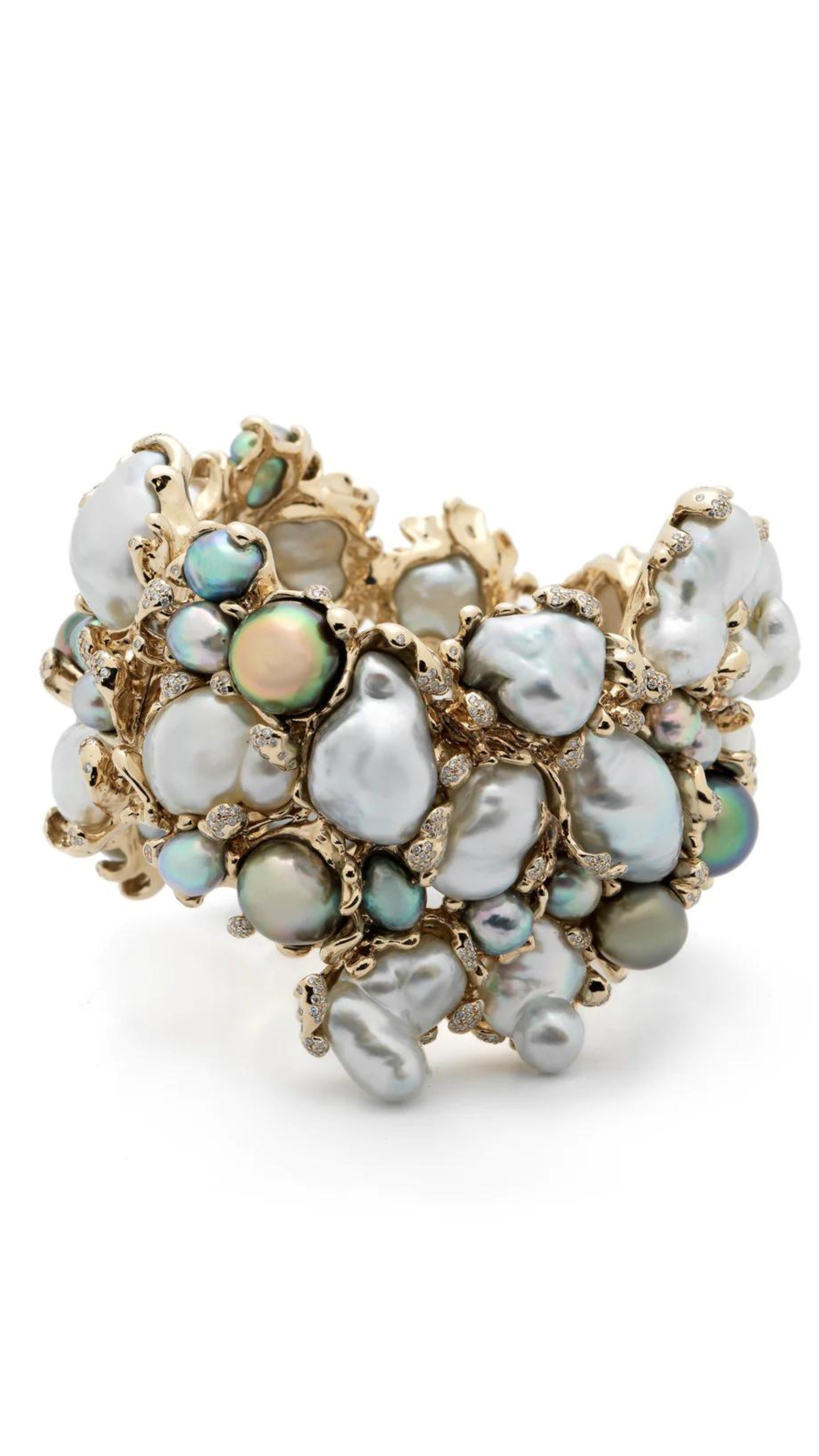 Bibi van der Velden Rock Pool Bracelet. A large cuff bracelet in 18k white gold and a dazzling cluster of Keshi pearls to create an organic shape with beautiful iridescent tones of blue, white, and grey pearls. The bracelet is further adorned with white diamonds.