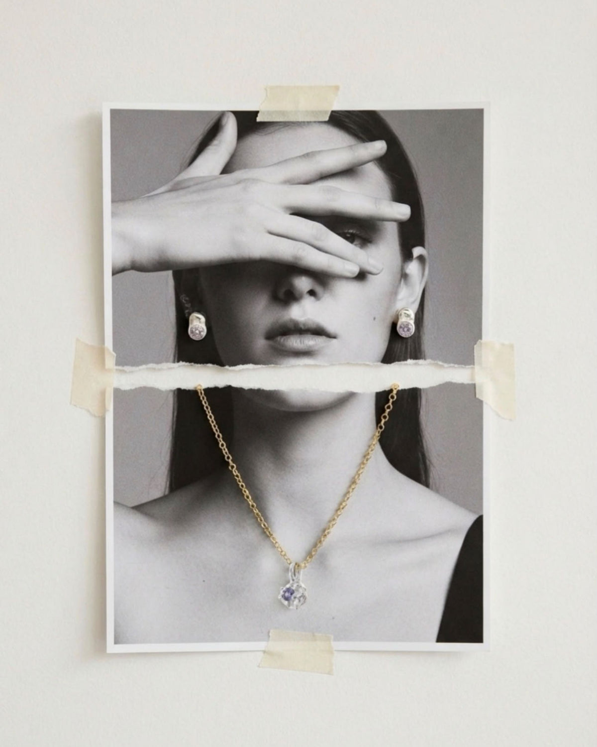 Black and white editorial image of a model wearing amethyst stud earrings and the amethyst pendant necklace