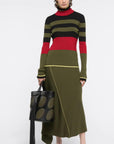 Colville AZ Factory Molly Molloy and Lucinda Chambers, Color Block Crewneck Sweater with Snood. Long sleeve sweater with crew neckline in varying stripes of black, olive and red with high light of yellow at bottom hem and cuffs. Shown on Model facing front with snood on.