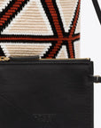 AZ Factory Colville Molly Molloy Lucinda Chambers, WOVEN CABRAS BAG  The Cabras Bag is woven in Wayuu Colombian and finished with Italian leather craftsmanship. Its ecru and burgundy diamond pattern is enhanced with black leather trim and a long black tassel. Shown with the interior leather pouch.