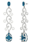 Conde de diamante Eden Earrings. 18K white gold drop earrings  Featuring a London Blue Topaz stud and tendrils of white gold with pave white diamonds and a second London Blue Topz Drop at the bottom. Product photo from the side.