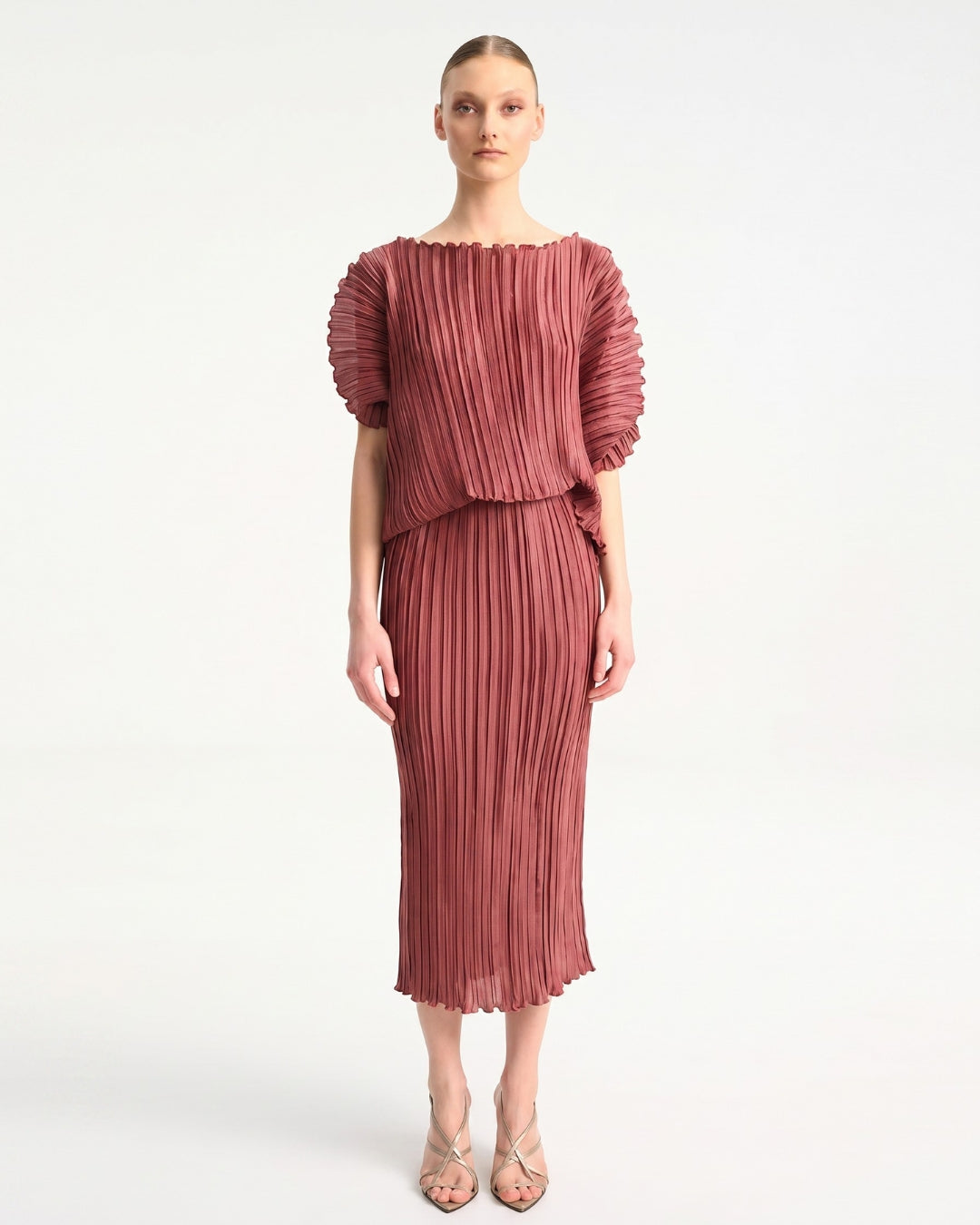 Daphne Valente Magnet Dress in Pomegranate — front view showing draped bodice and pleated skirt