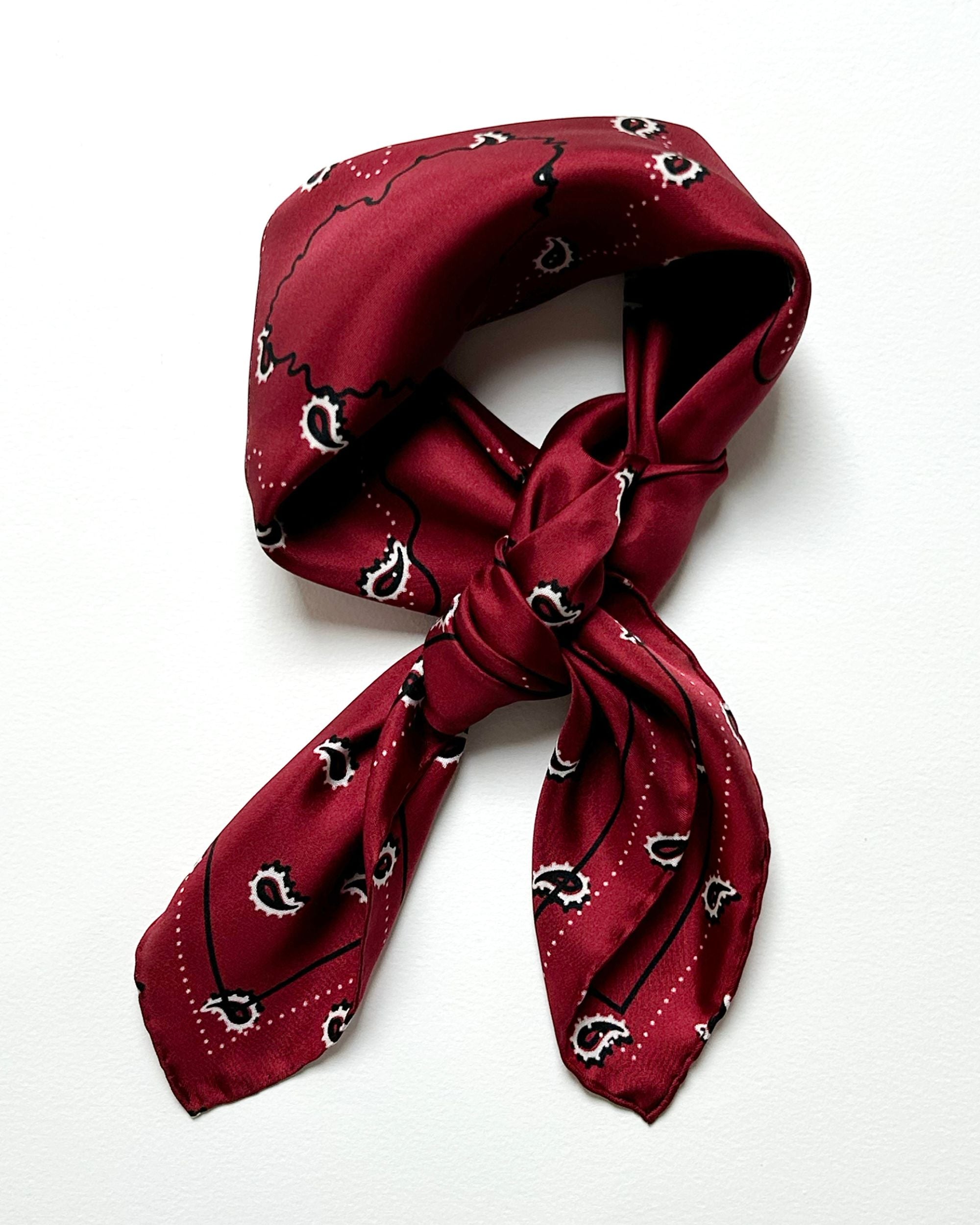 Red silk scarf styled as bandana showing heart detail
