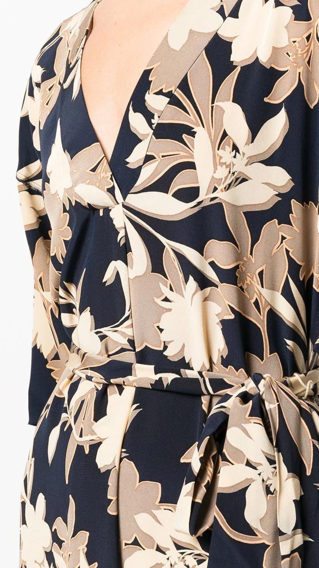 St John Knits Floral Print Silk Midi Dress. Kimono style dress in natural tones and navy blue. With a silk tie belt and half length sleeves. Midi length. Shown on model  detail of neckline.