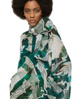 For Restless Sleepers Arpocrate Silk Dress. With dramatic oversized raglan sleeves and neck scarf. Long dress in green and ivory. Shown on model facing forward close up of top detail.