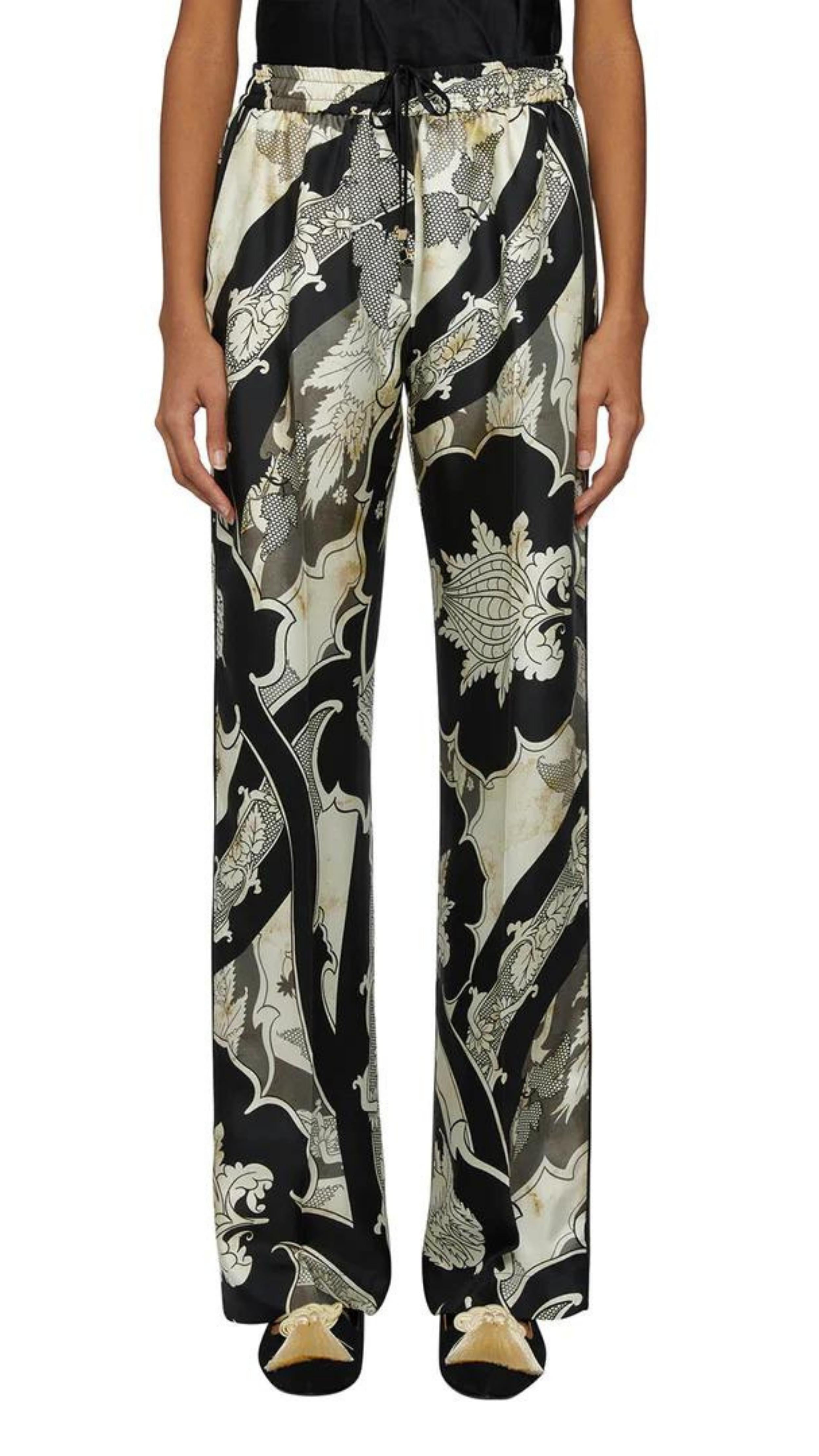 For Restless Sleepers Doride Trousers in Black and Ivory. Elastic waist straight leg pant n 100% silk. Pajama style in beautiful black and white print. Shown on model facing forward.