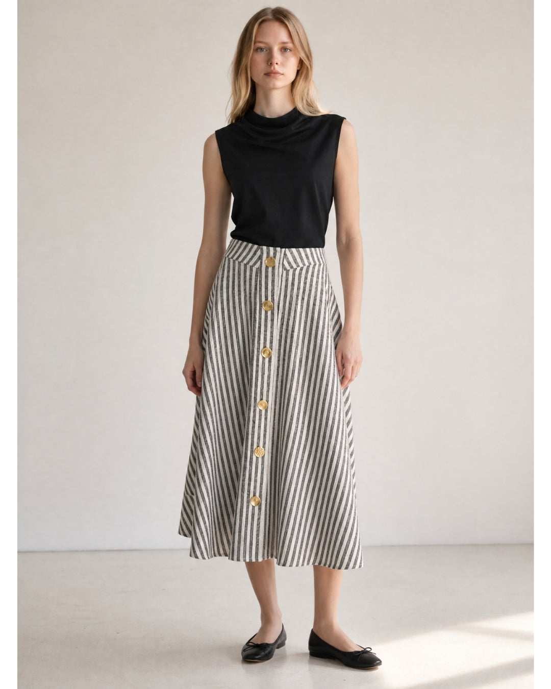 Model wearing Françoise Maia Skirt in black and ivory stripe, styled with black sleeveless top and ballet flats