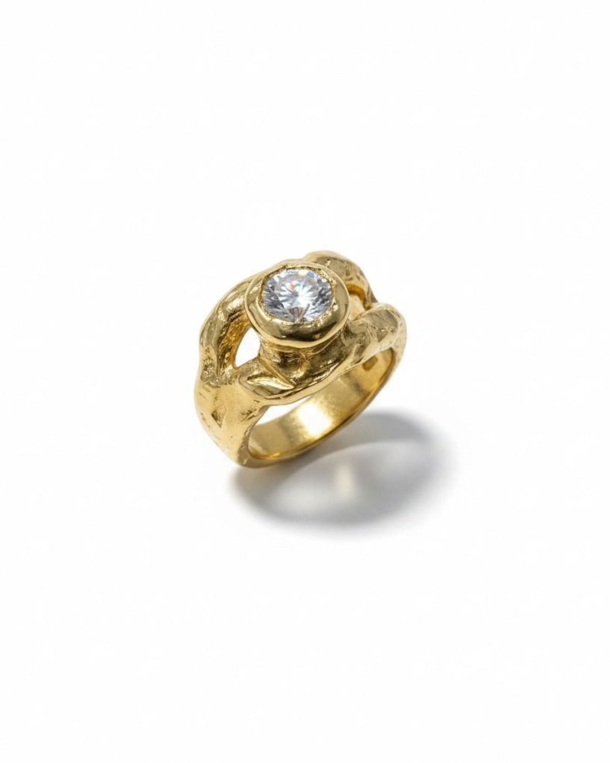 Angled front view of an 18k gold vermeil ring with a round lab-created white stone in a sculptural open-loop setting, on white background