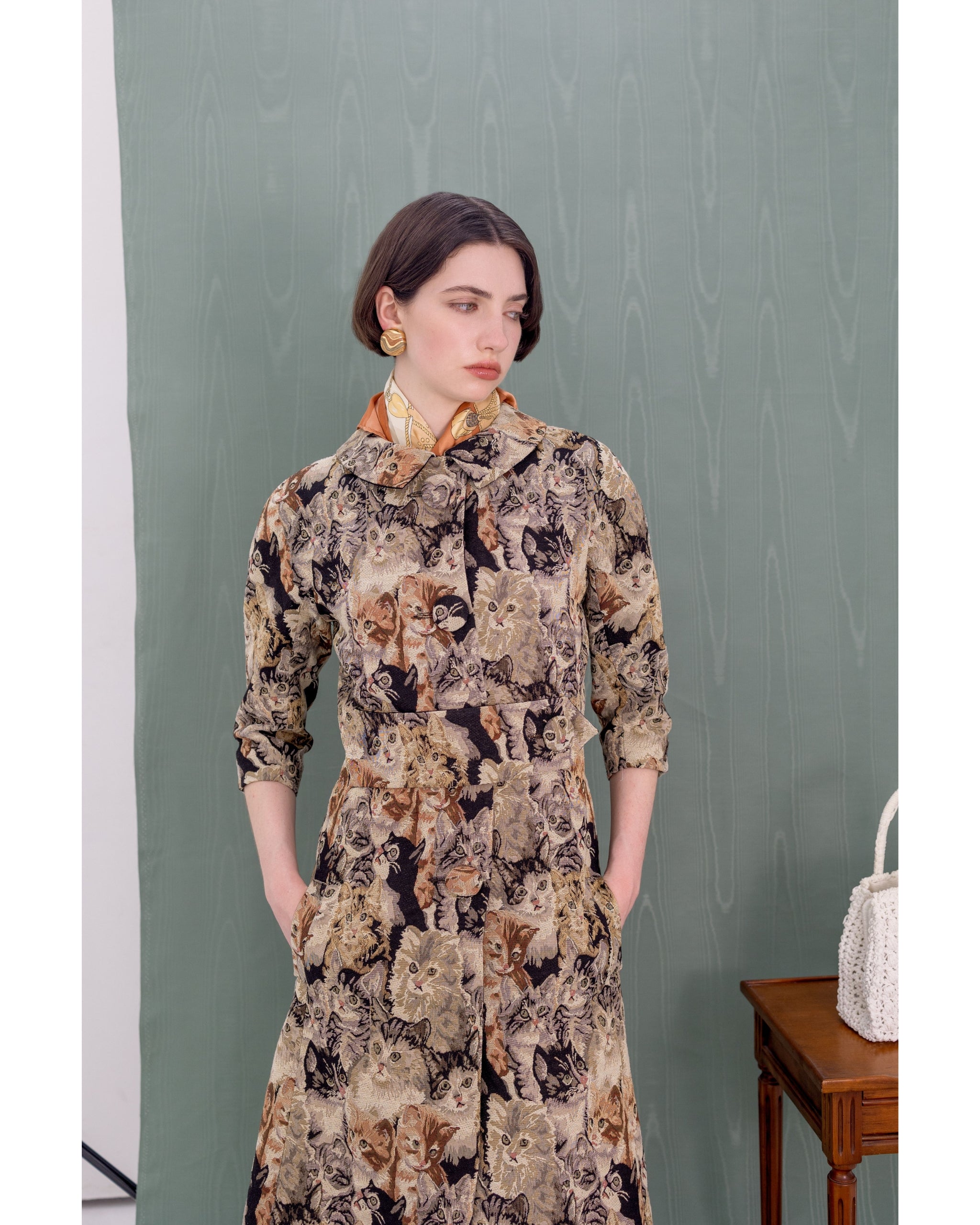 Close-up of cat jacquard fabric and covered buttons on Henri Paris Cat Coat