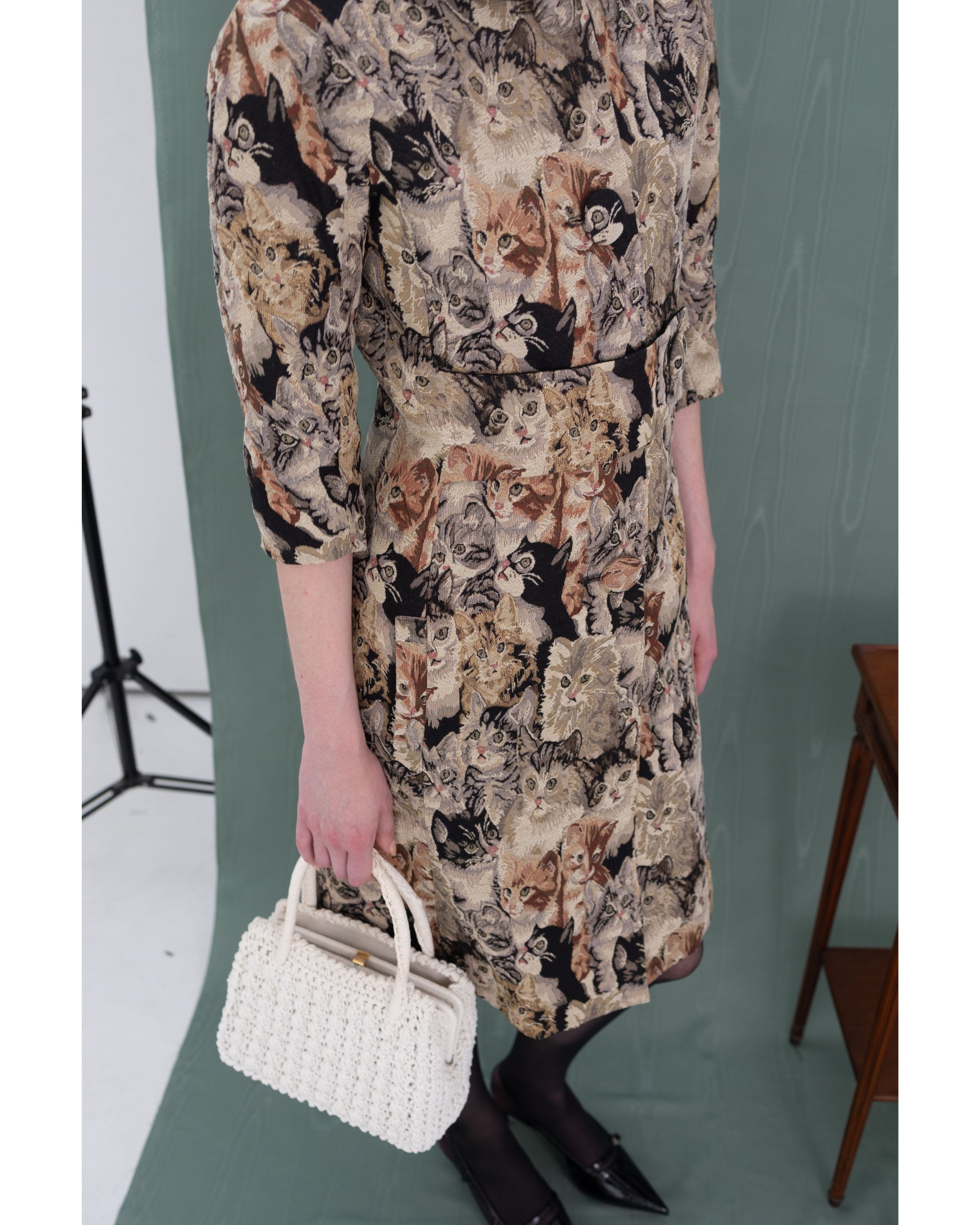 Side view close-up of jacquard texture and button detailing on Henri Paris Cat Coat