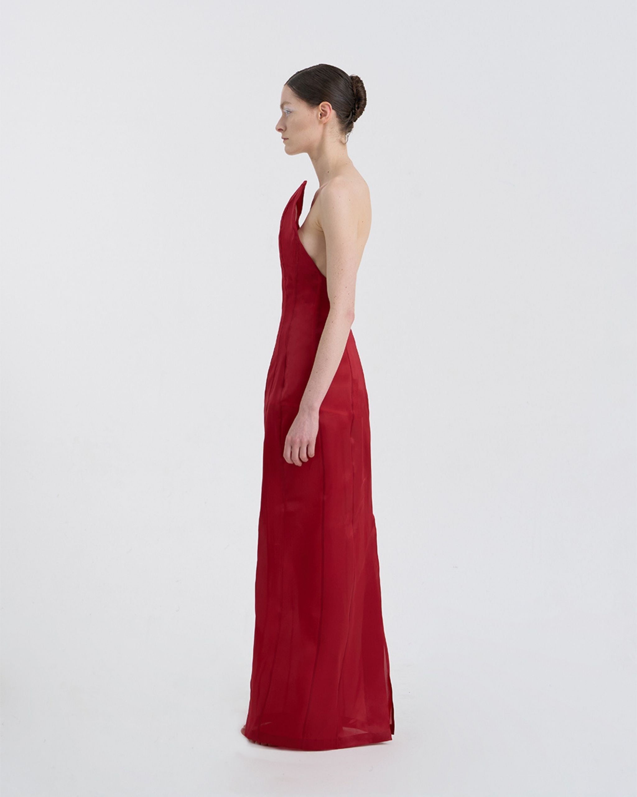 Side view of JINSUN Corset Silk Gown showing curved neckline and floor-length drape.