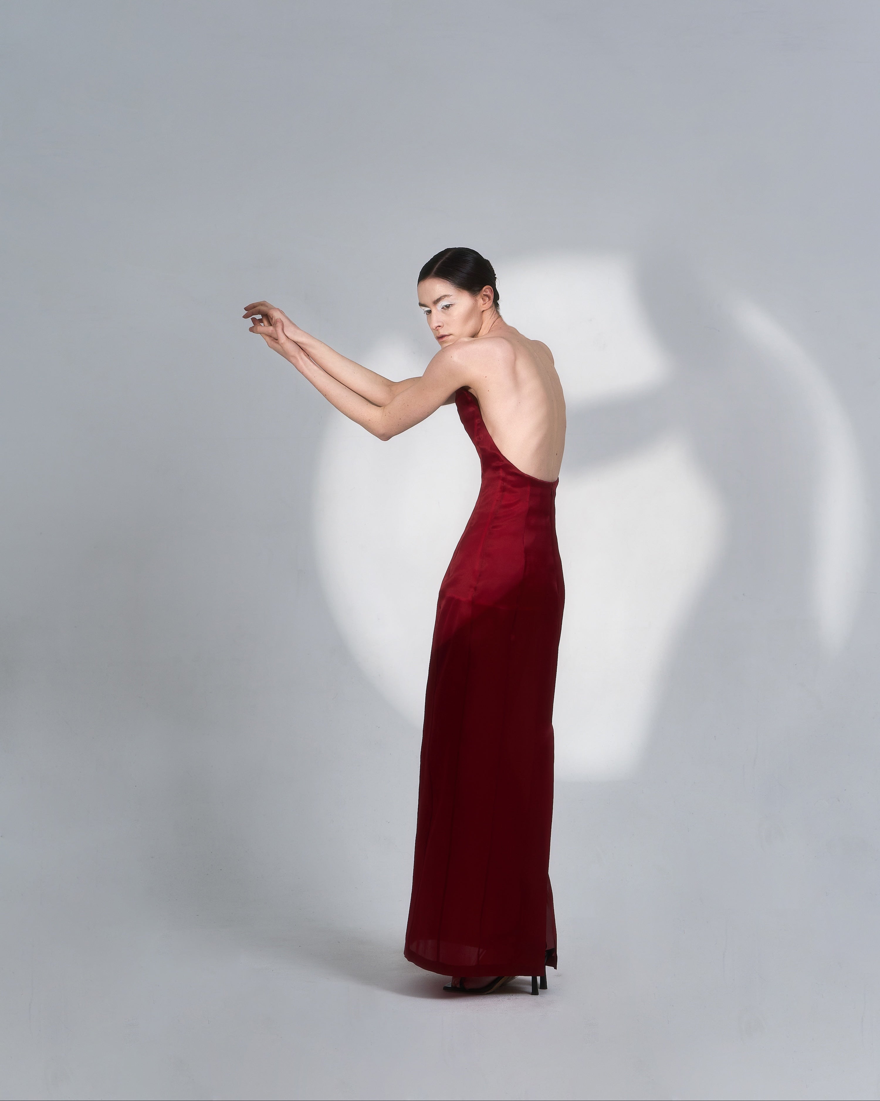 Fabric detail of JINSUN Corset Silk Gown highlighting red silk texture and tailored lines.