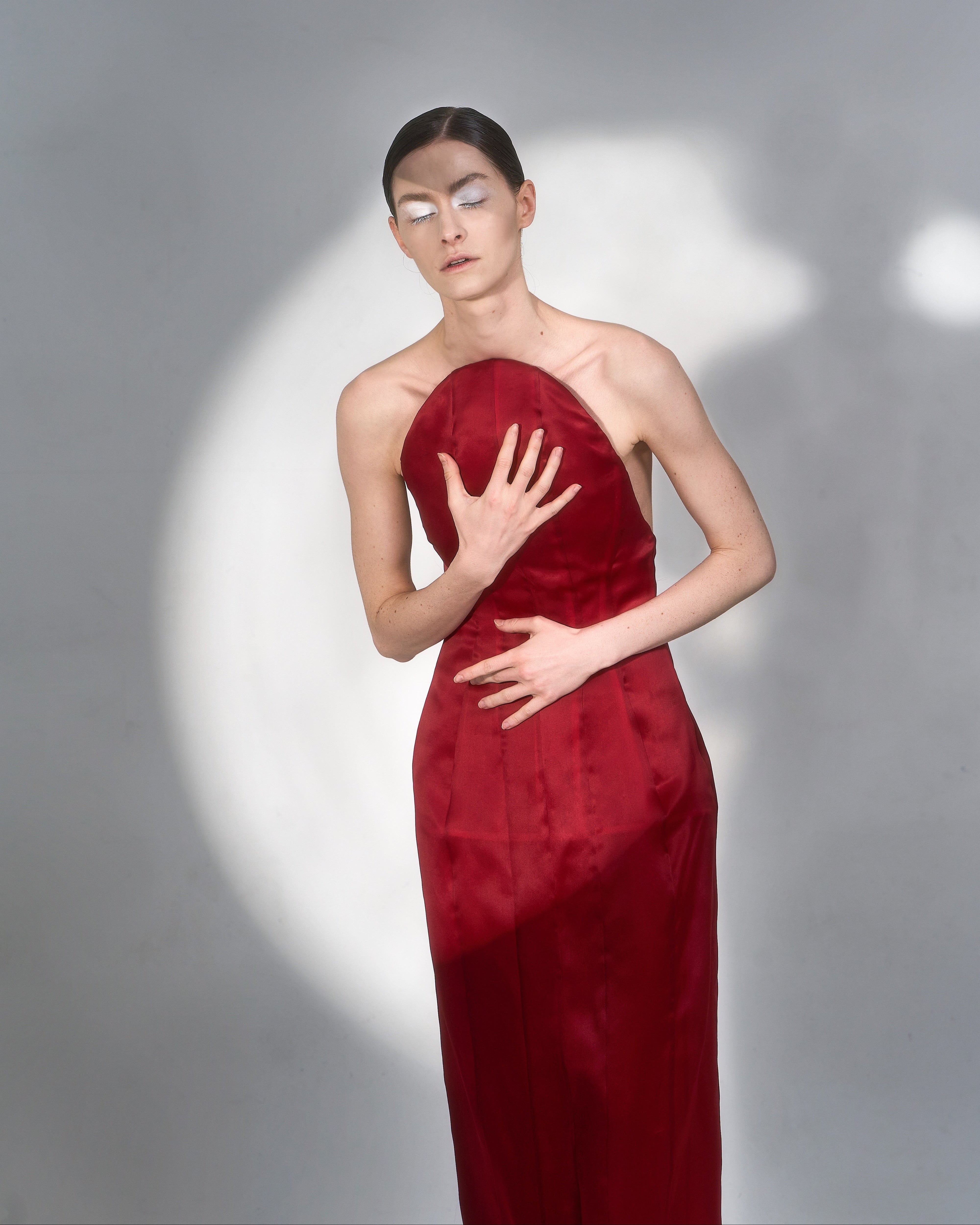 Fabric detail of JINSUN Corset Silk Gown highlighting red silk texture and tailored lines.