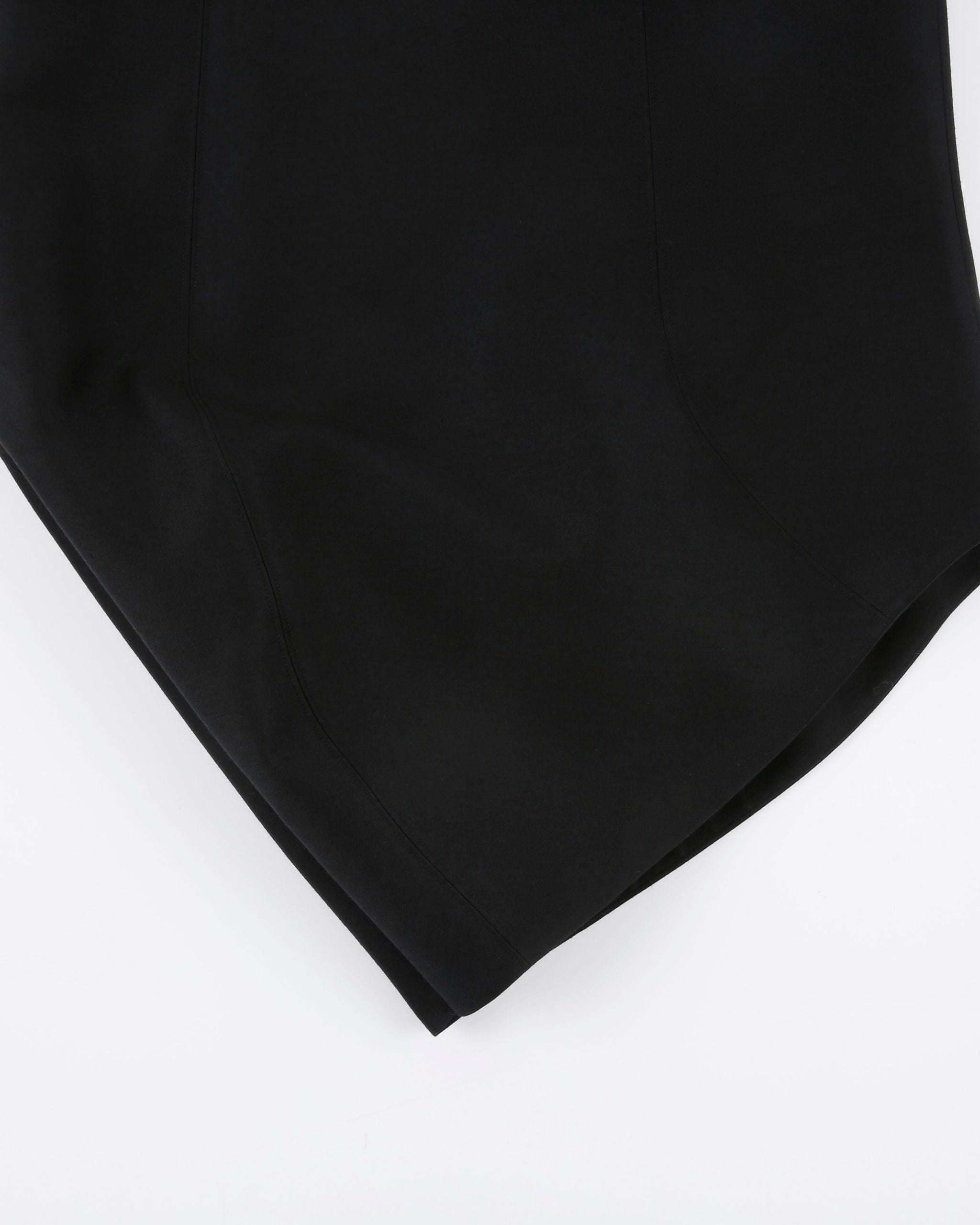 Detail close-up of JINSUN Morph Wool Silk Skirt showing curved hem construction.