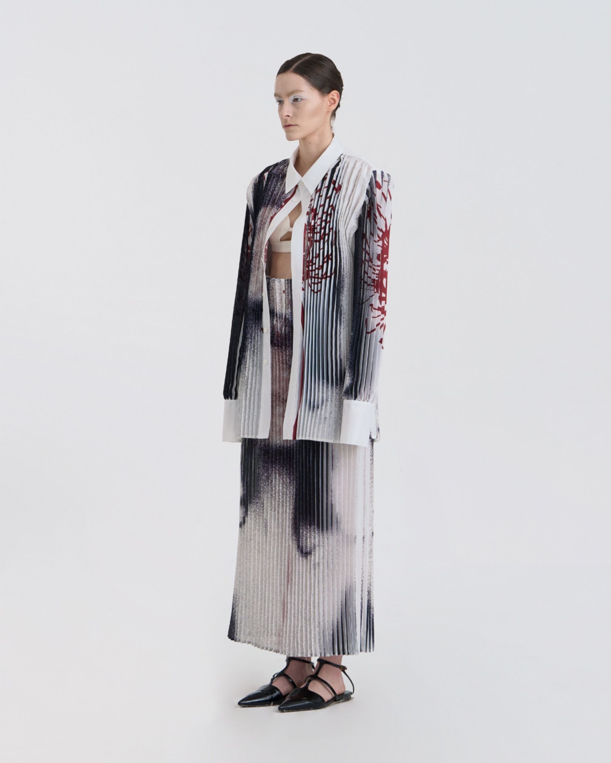 Three-quarter view of model in JINSUN Anamo Printed Shirt with structured collar and extended cuffs