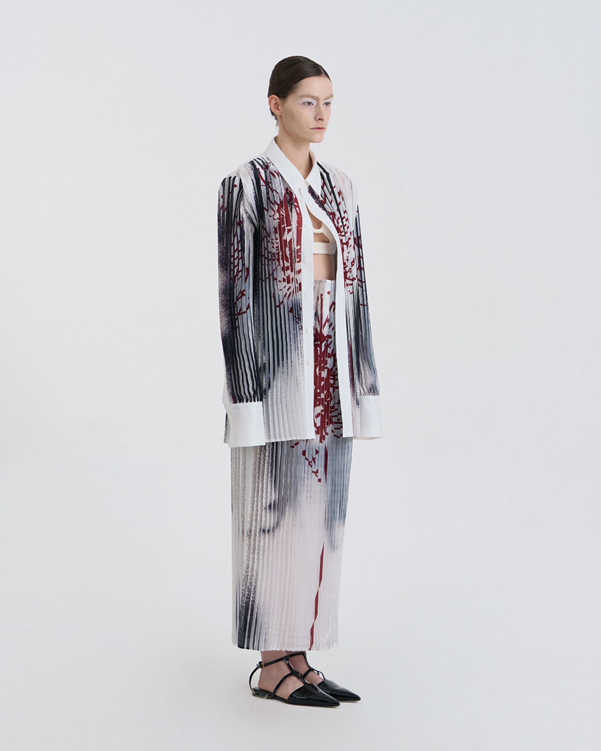 Three-quarter view of model in JINSUN Anamo Printed Shirt with structured collar and extended cuffs