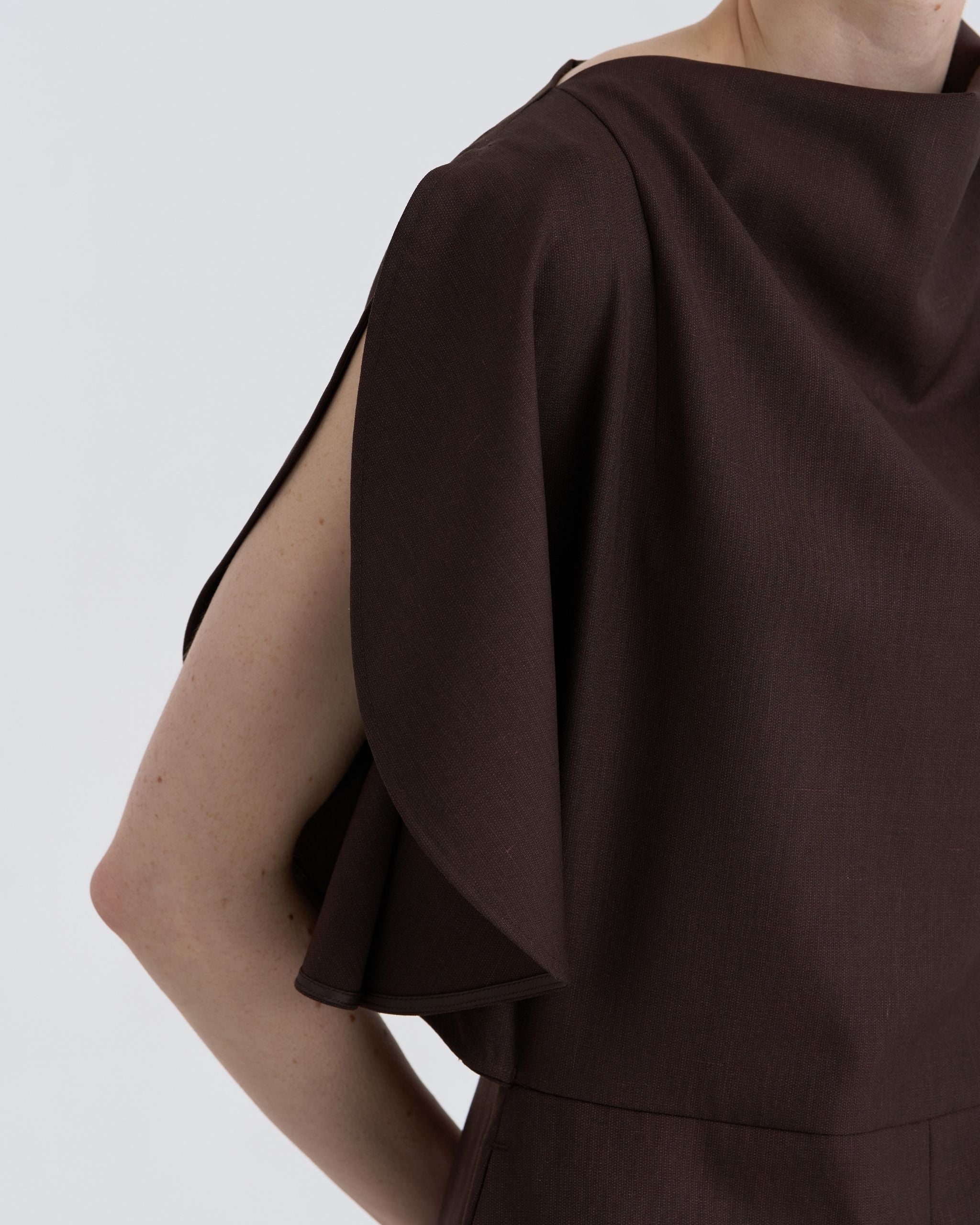 Close-up of JINSUN Filante Wool Jumpsuit fabric texture and neckline drape