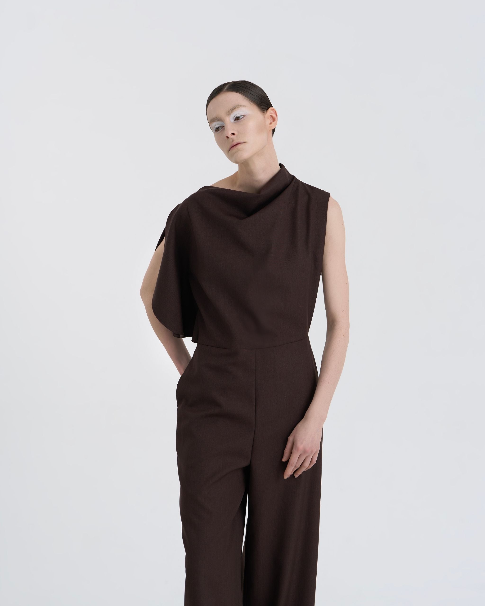 Three-quarter view of model in JINSUN Filante Wool Jumpsuit in espresso brown