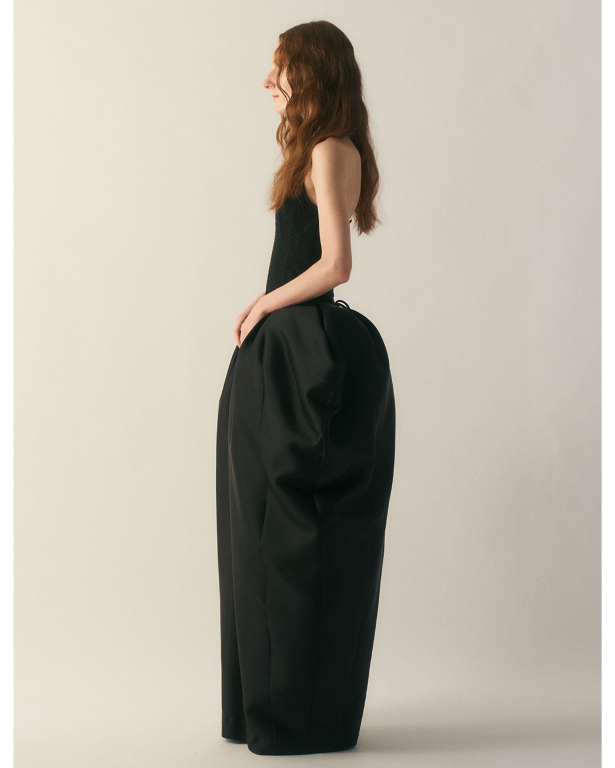 Side profile of the gown highlighting structured volume
