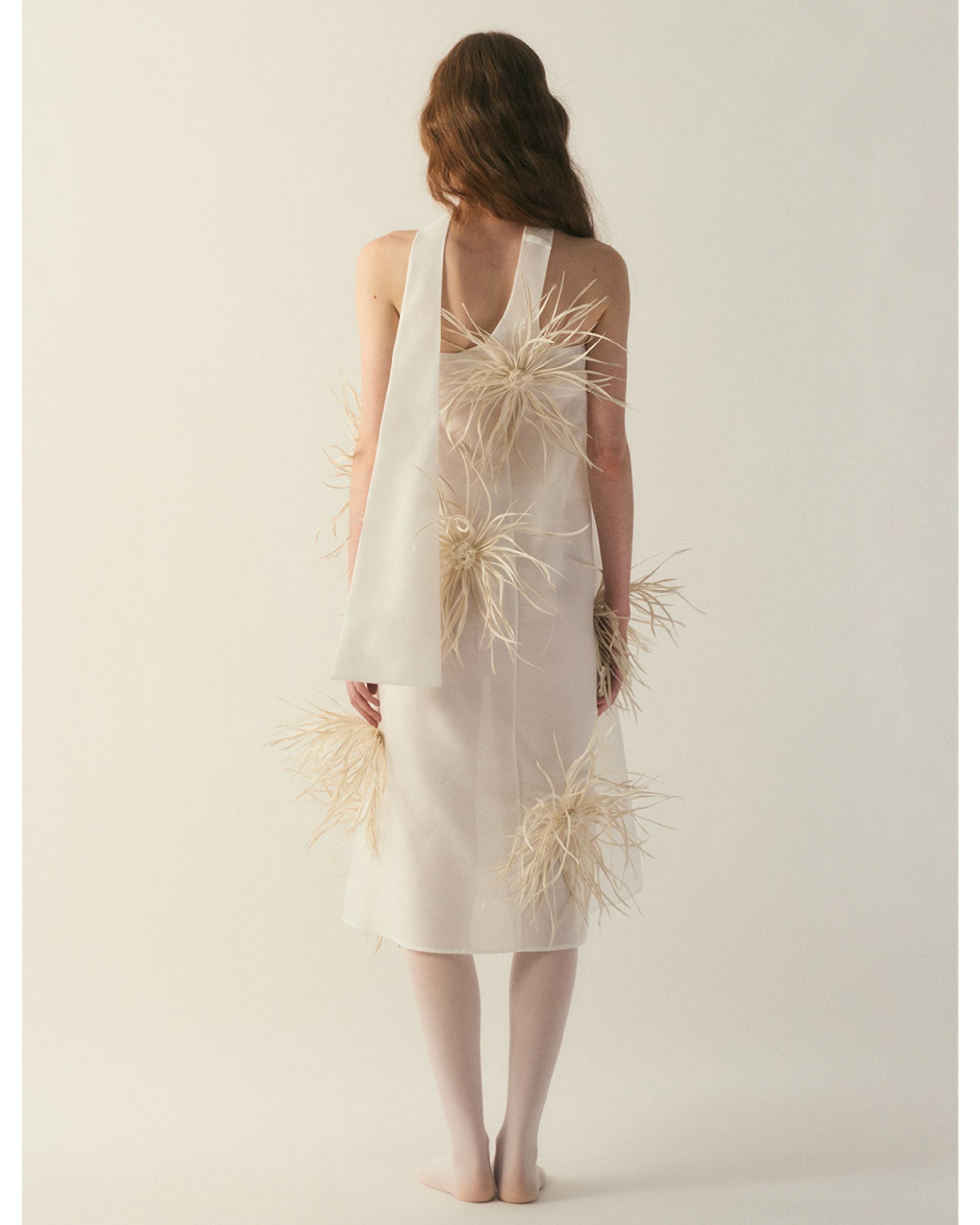 Back view of strapless silk-wool dress with extended scarf-tail panel
