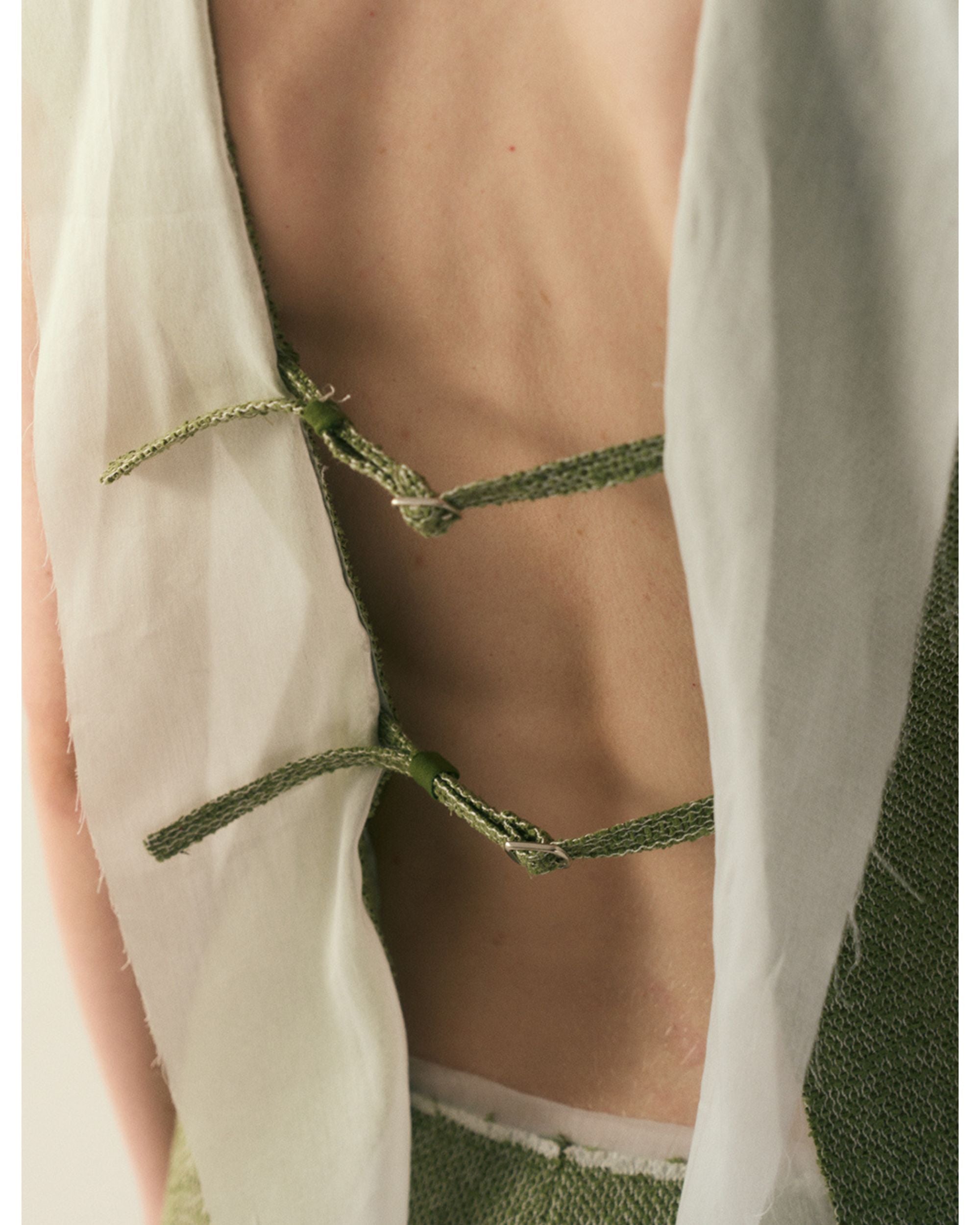 Detail of adjustable hook-and-eye fastening at back
