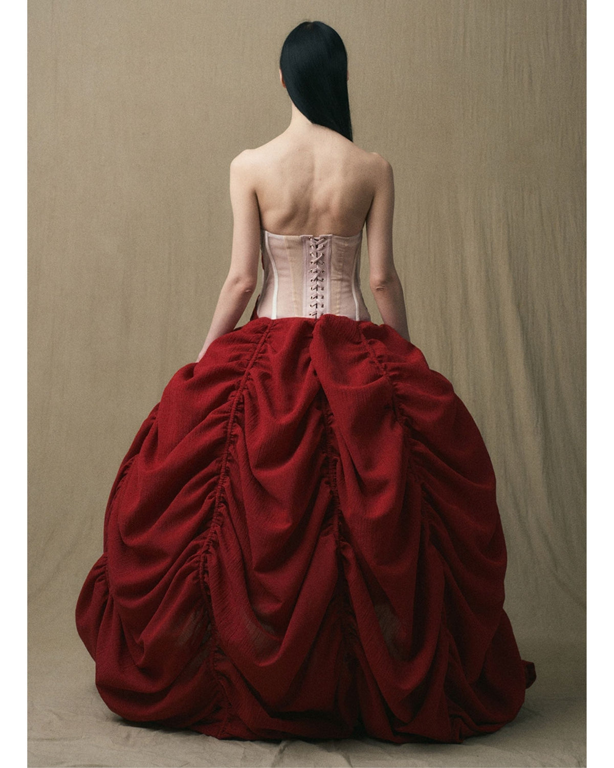 Back view showing the exposed lace-up corset and gathered skirt

