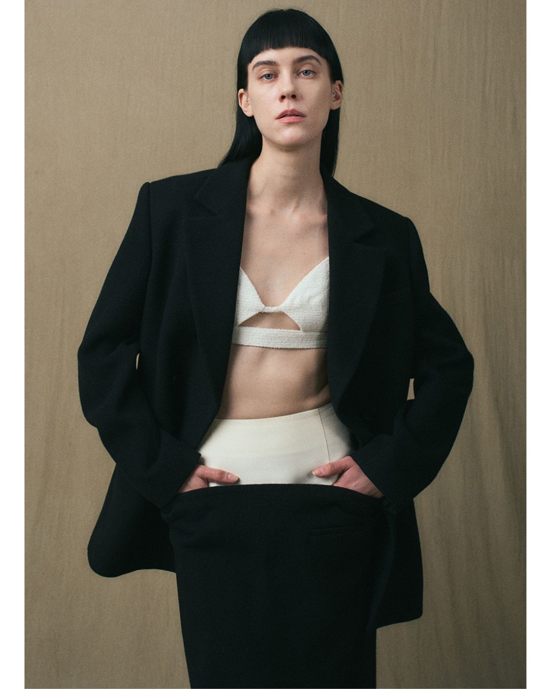 JINSUN Double-Breasted Wool Jacket in black styled open with the matching maxi skirt