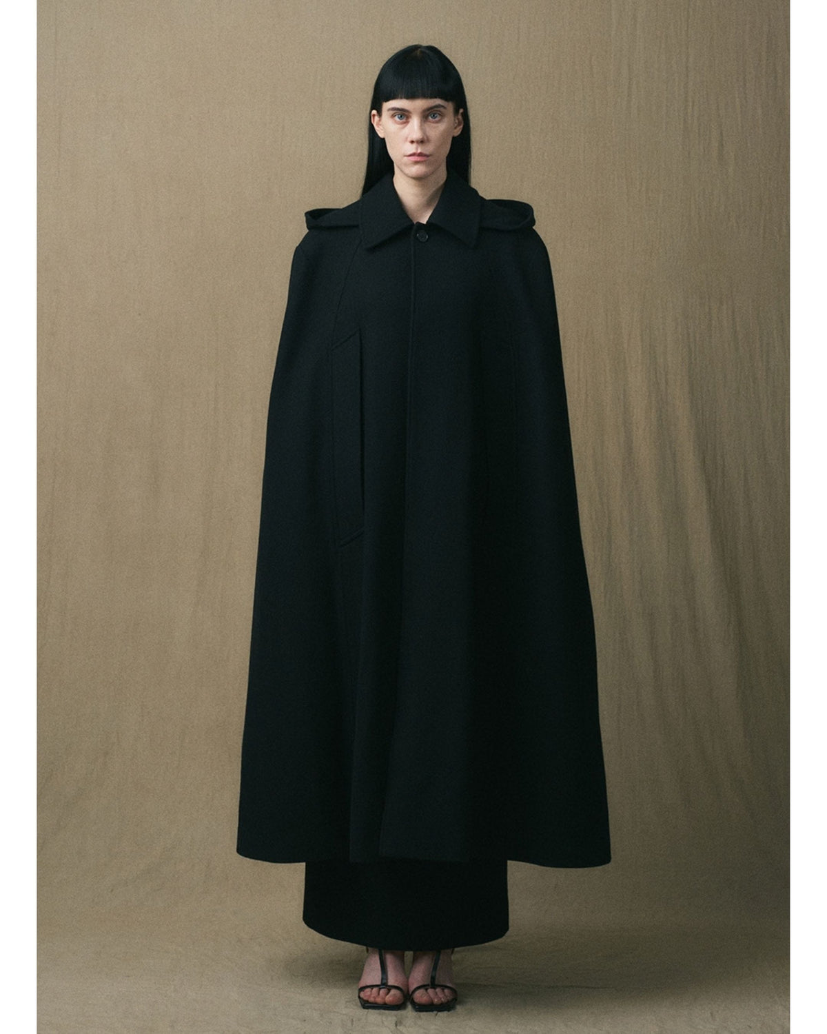 JINSUN black wool cape coat with sweeping oversized silhouette