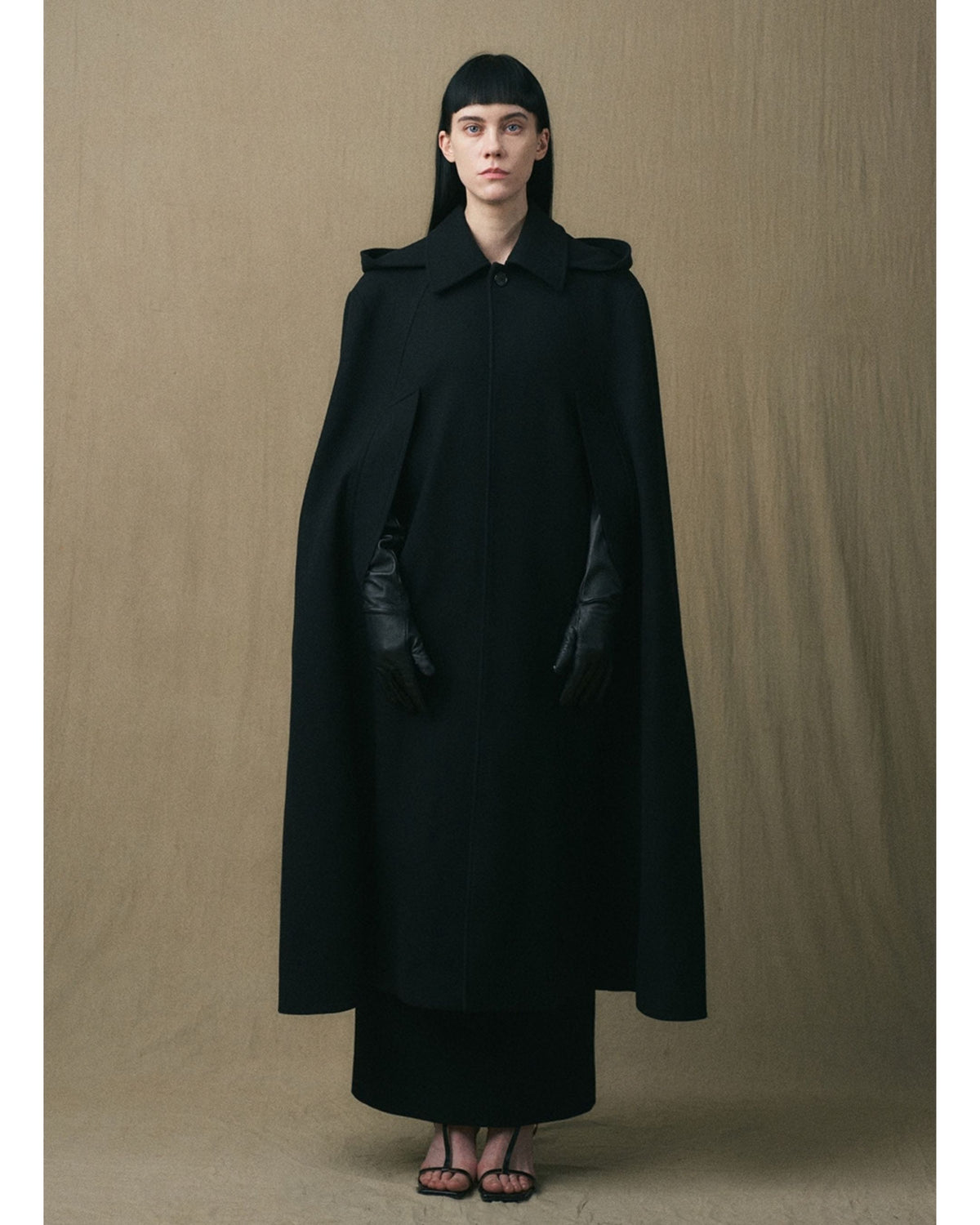 Full-length front view of the black JINSUN wool cape coat