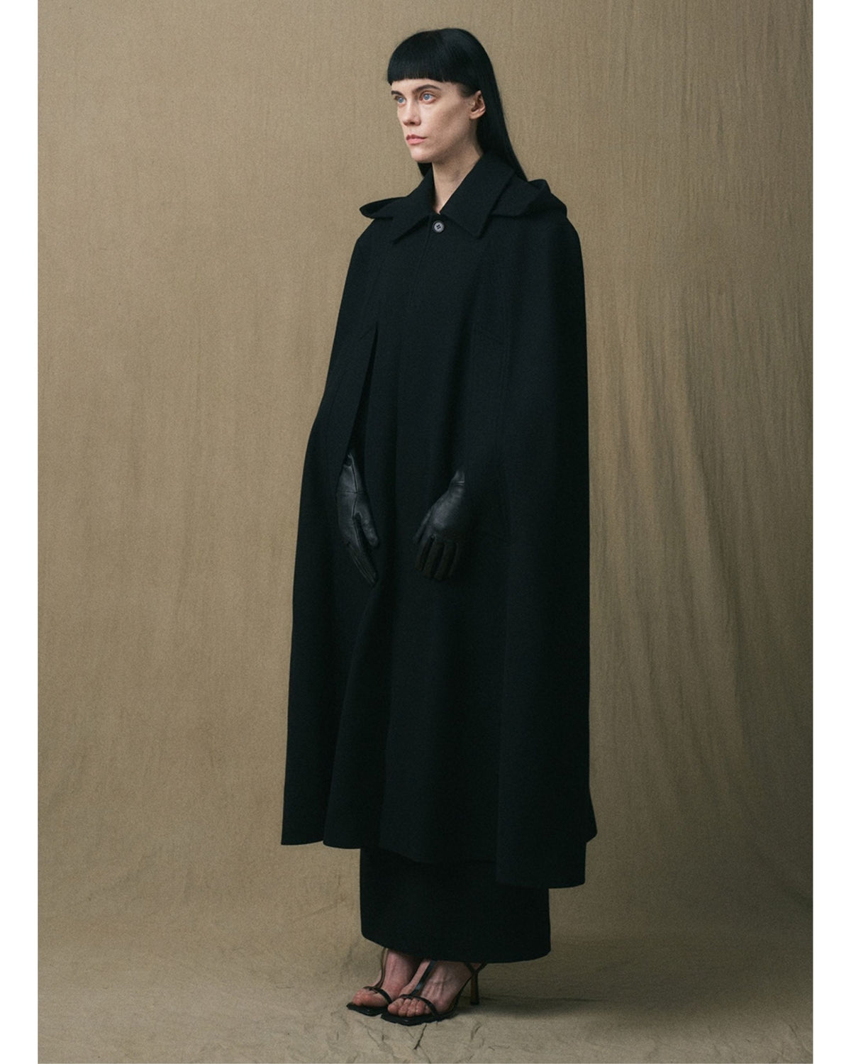 JINSUN Long Wool Cape Coat in black, three-quarter view