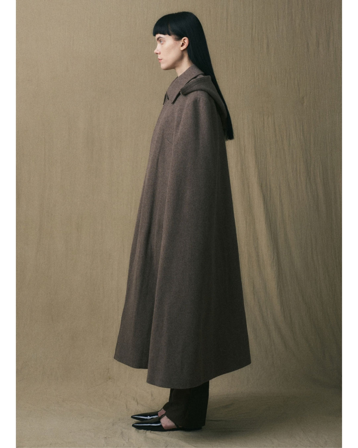 Side view of the JINSUN Long Wool Cape Coat in brown