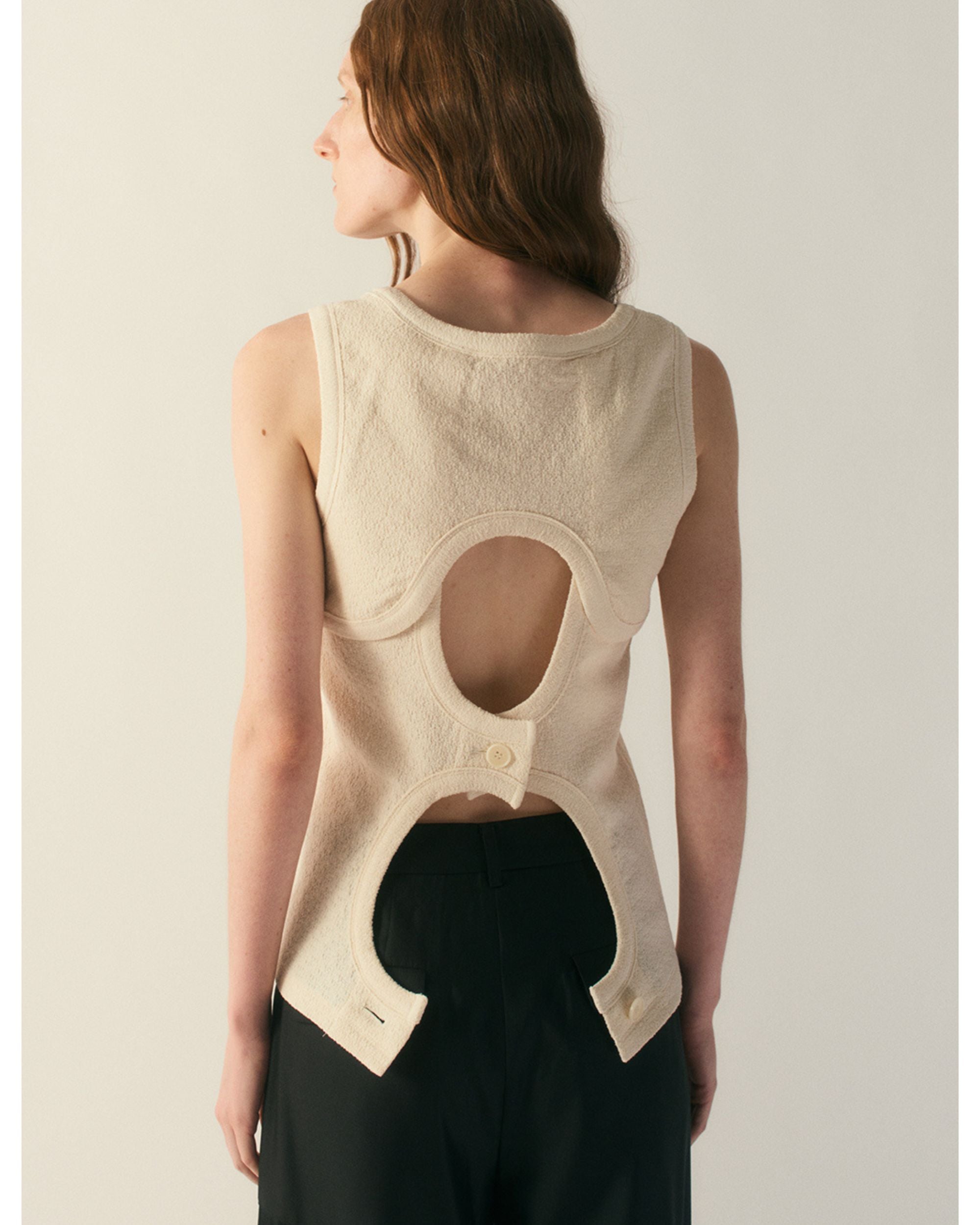 Back view of cream wool silk jersey top with oval back cut-out detail
