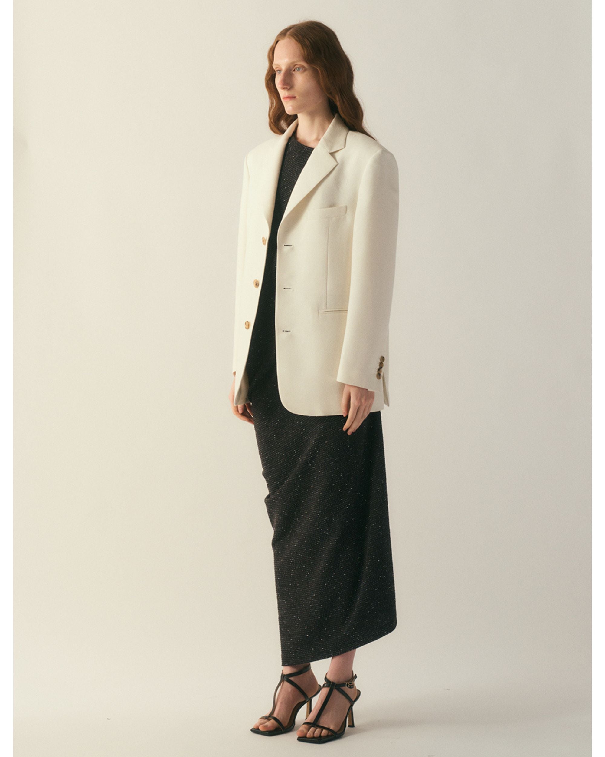 Side profile of the Veyra Wool Silk Jacket showing tailored structure
