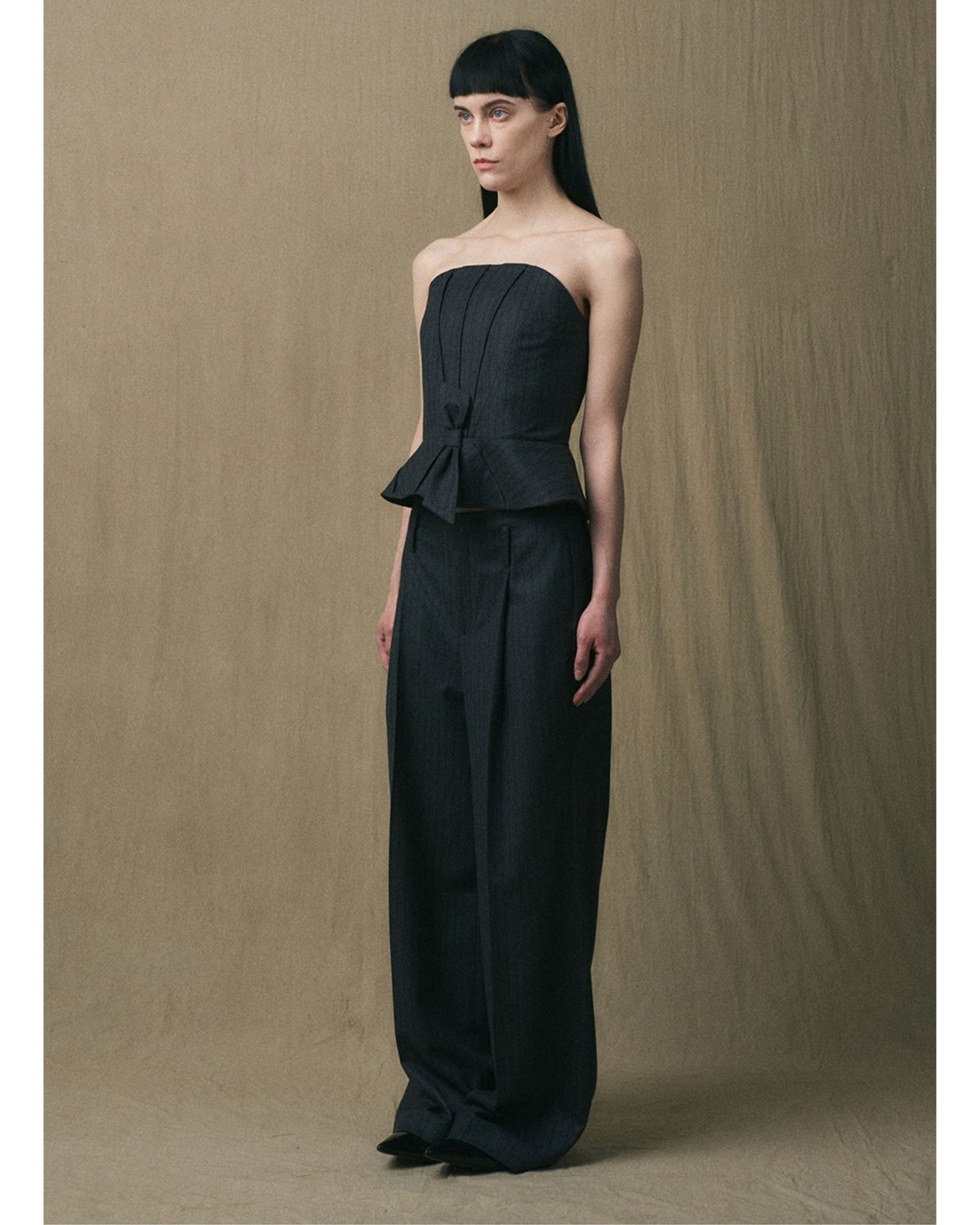 Three-quarter view of the JINSUN Wool Cashmere Pants styled with the matching strapless peplum top

