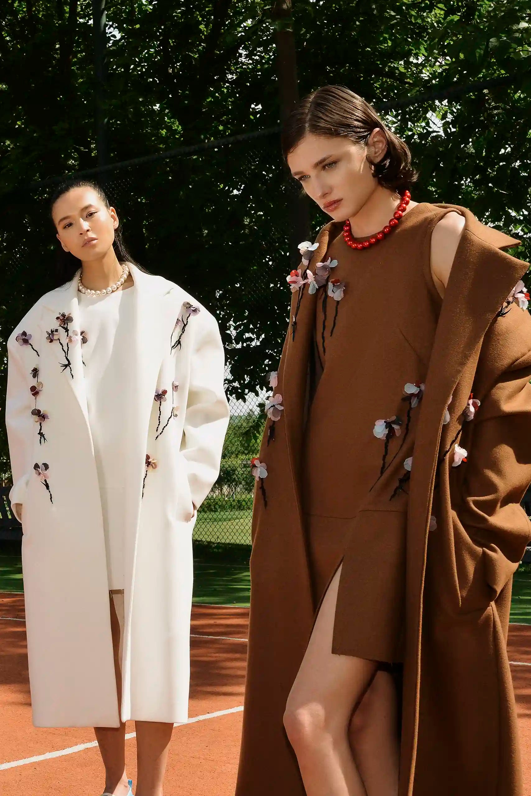 Three-quarter view of the Floris Coat worn open with floral detailing
