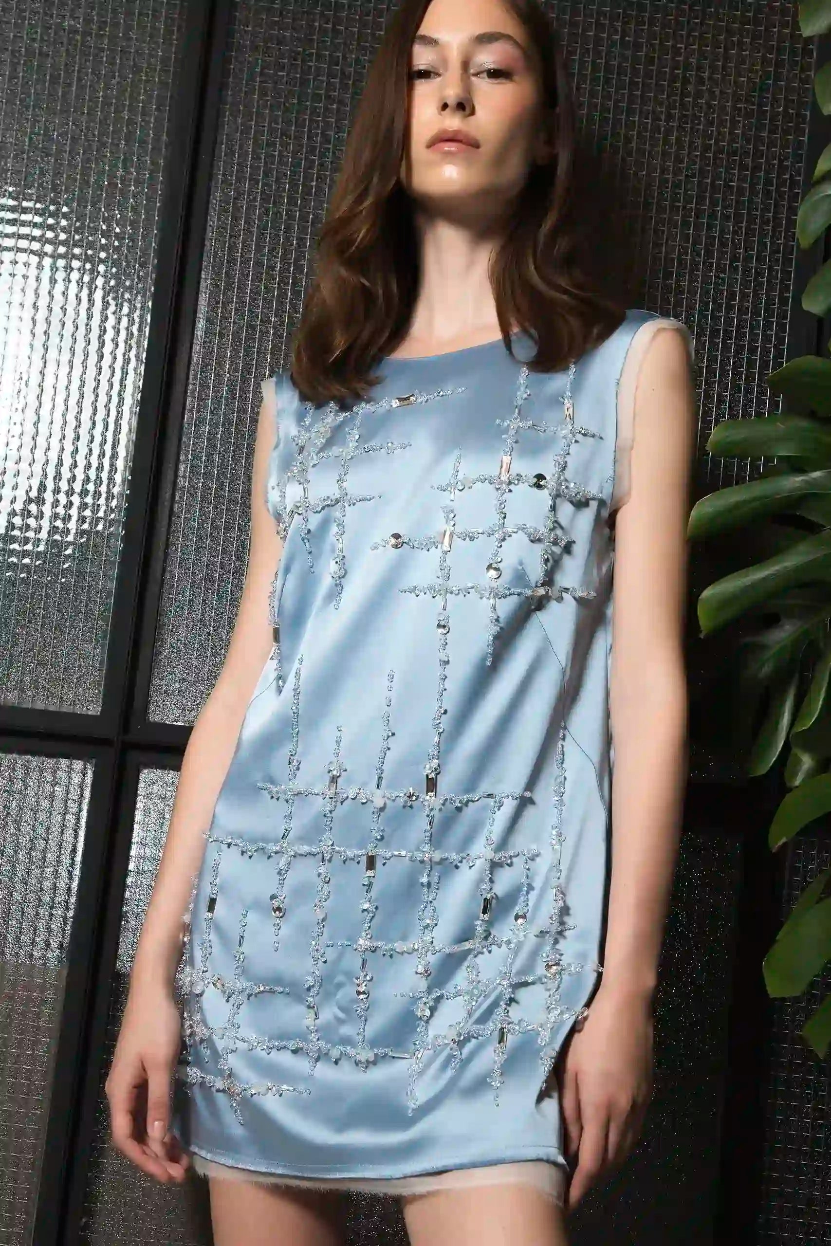 Model wearing sleeveless light blue silk dress